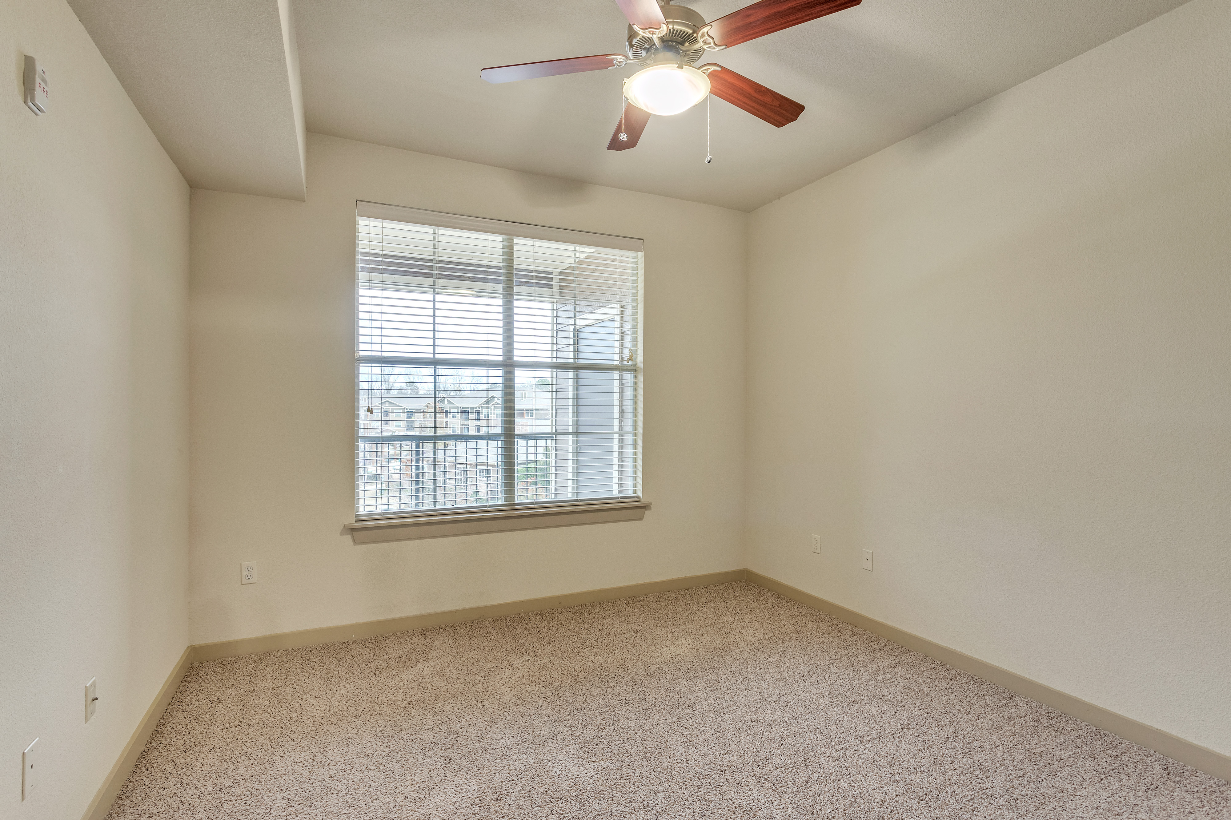 bedroom view with window ceiling fan and carpet Riverside at Rockwater Luxury Apartments North Littl