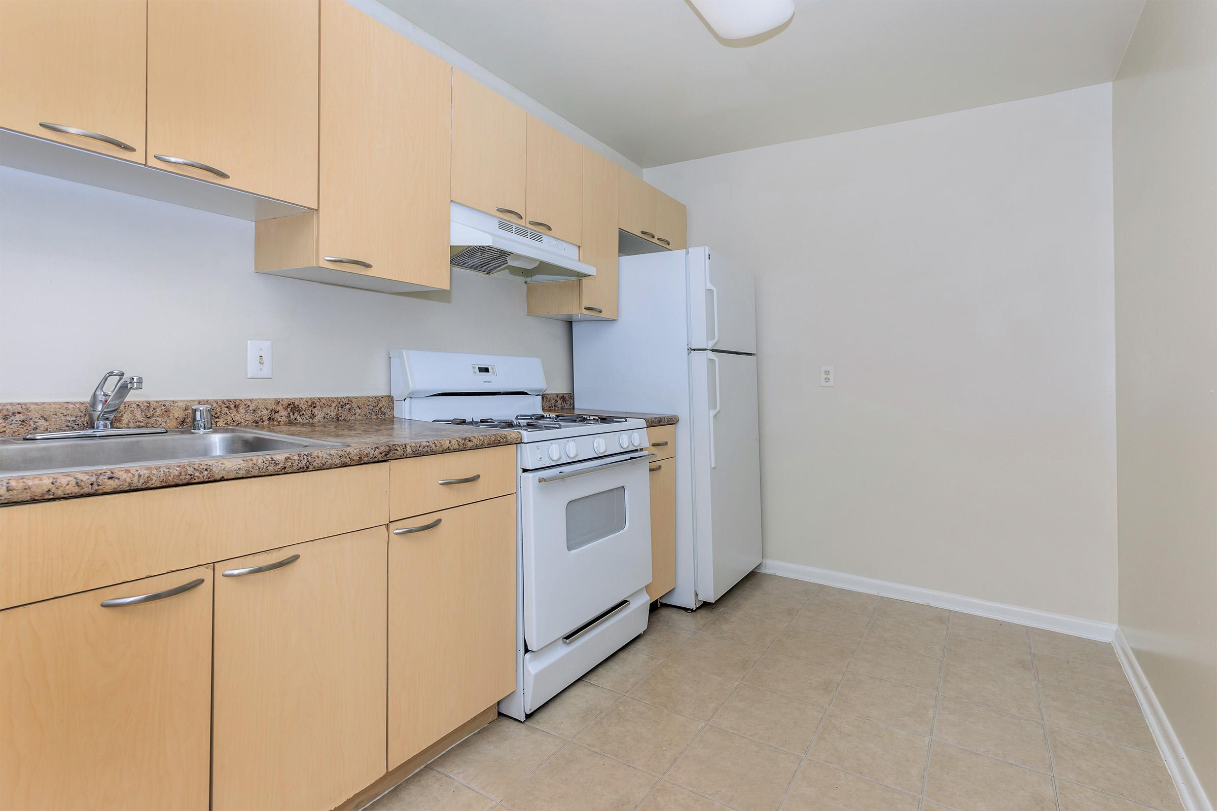 a kitchen with a stove and a refrigerator