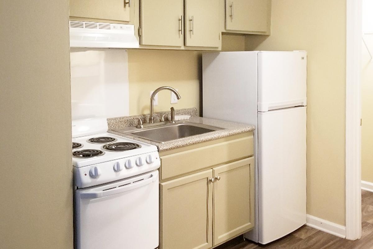 a kitchen with a white stove top oven sitting inside of a refrigerator
