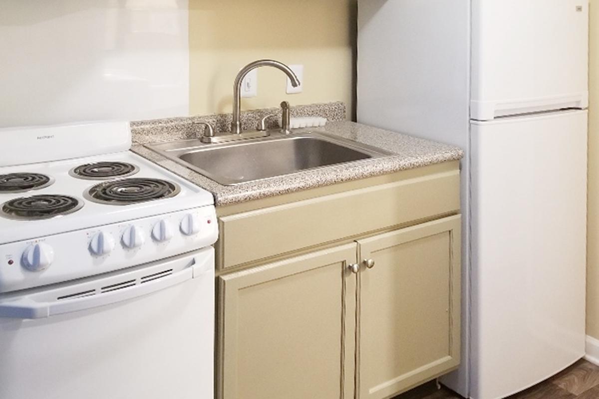 a white stove top oven sitting inside of a kitchen