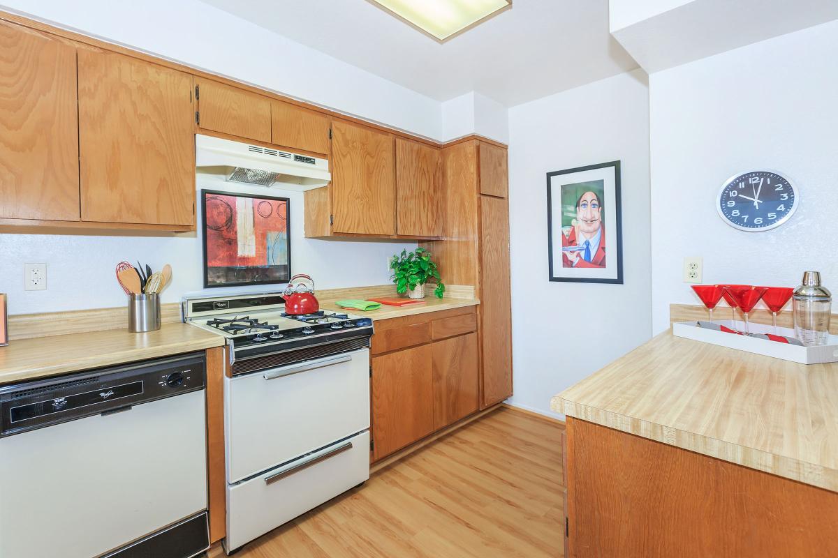 a kitchen with wooden cabinets