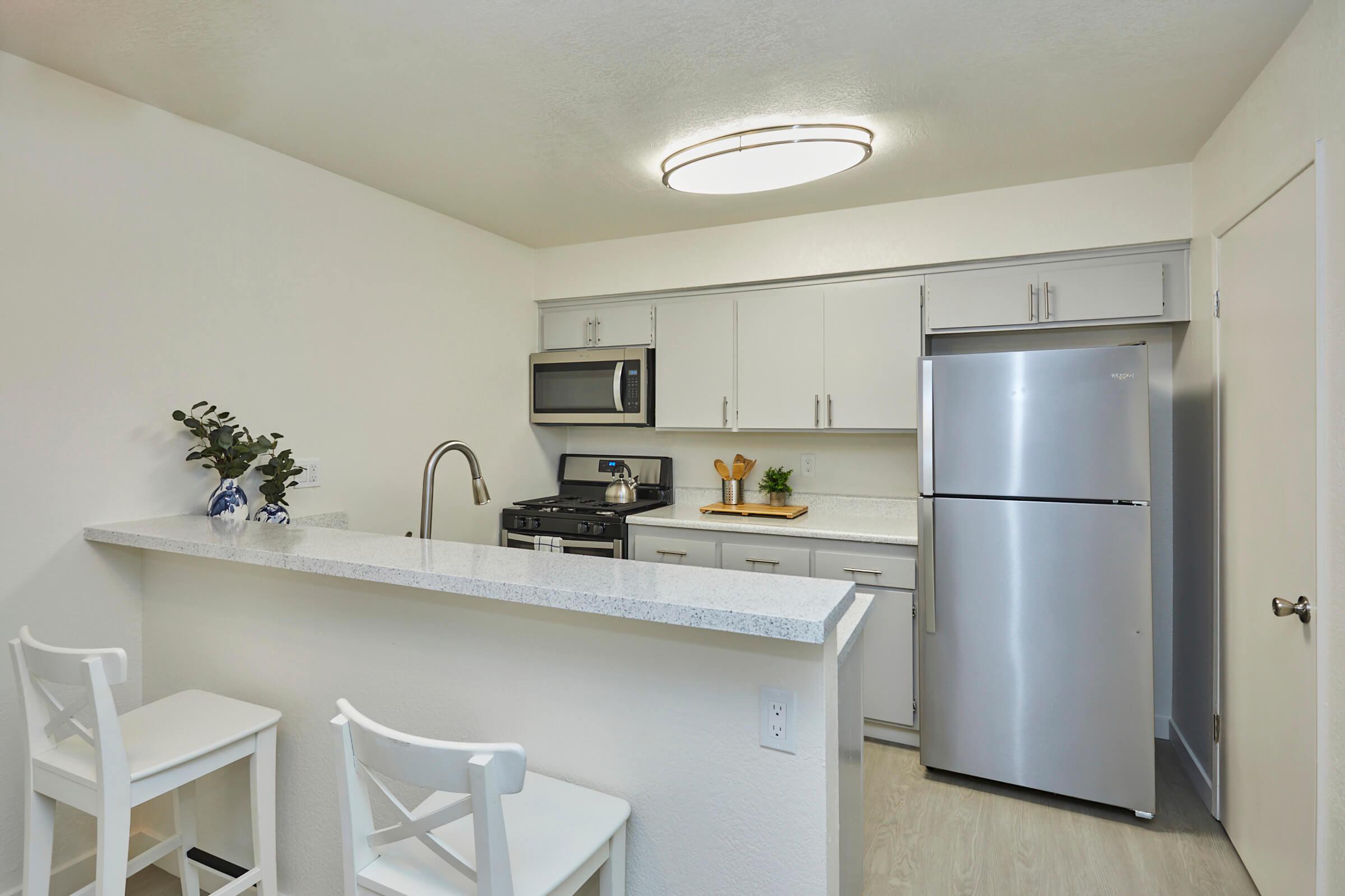 a kitchen with a sink and a refrigerator