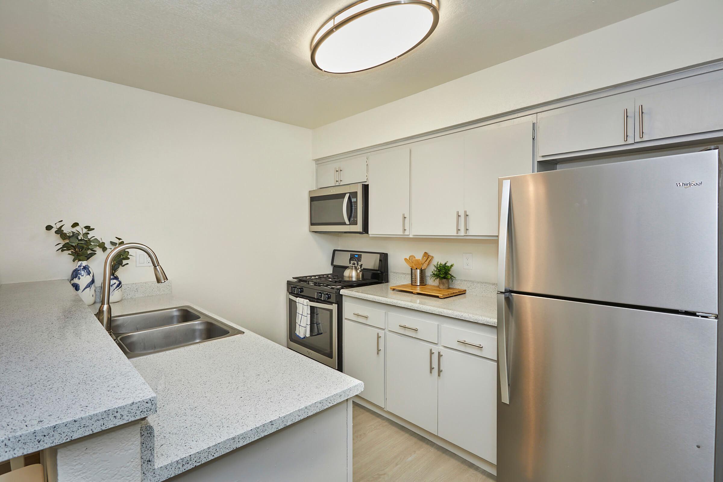 a kitchen with a sink and a refrigerator