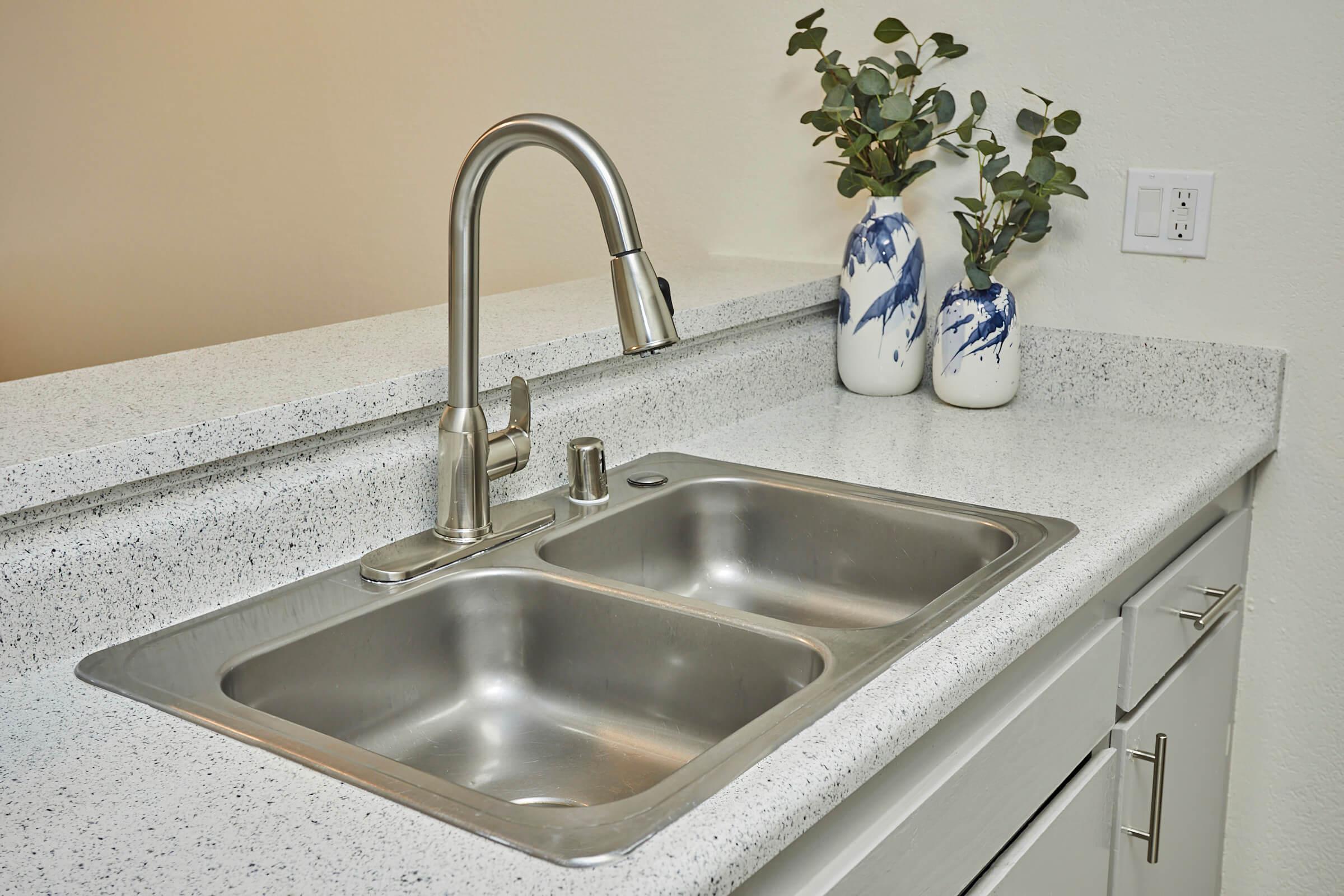 a kitchen with a sink and a mirror