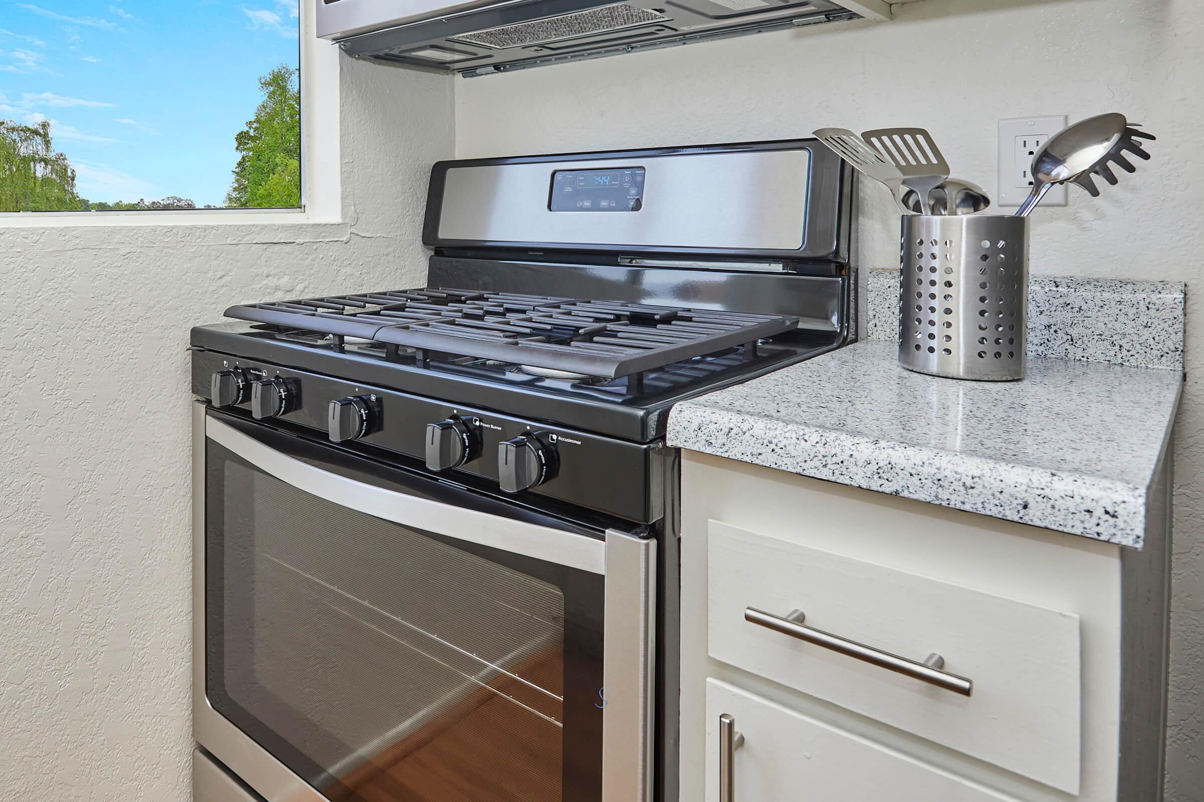 a stove top oven sitting inside of a kitchen