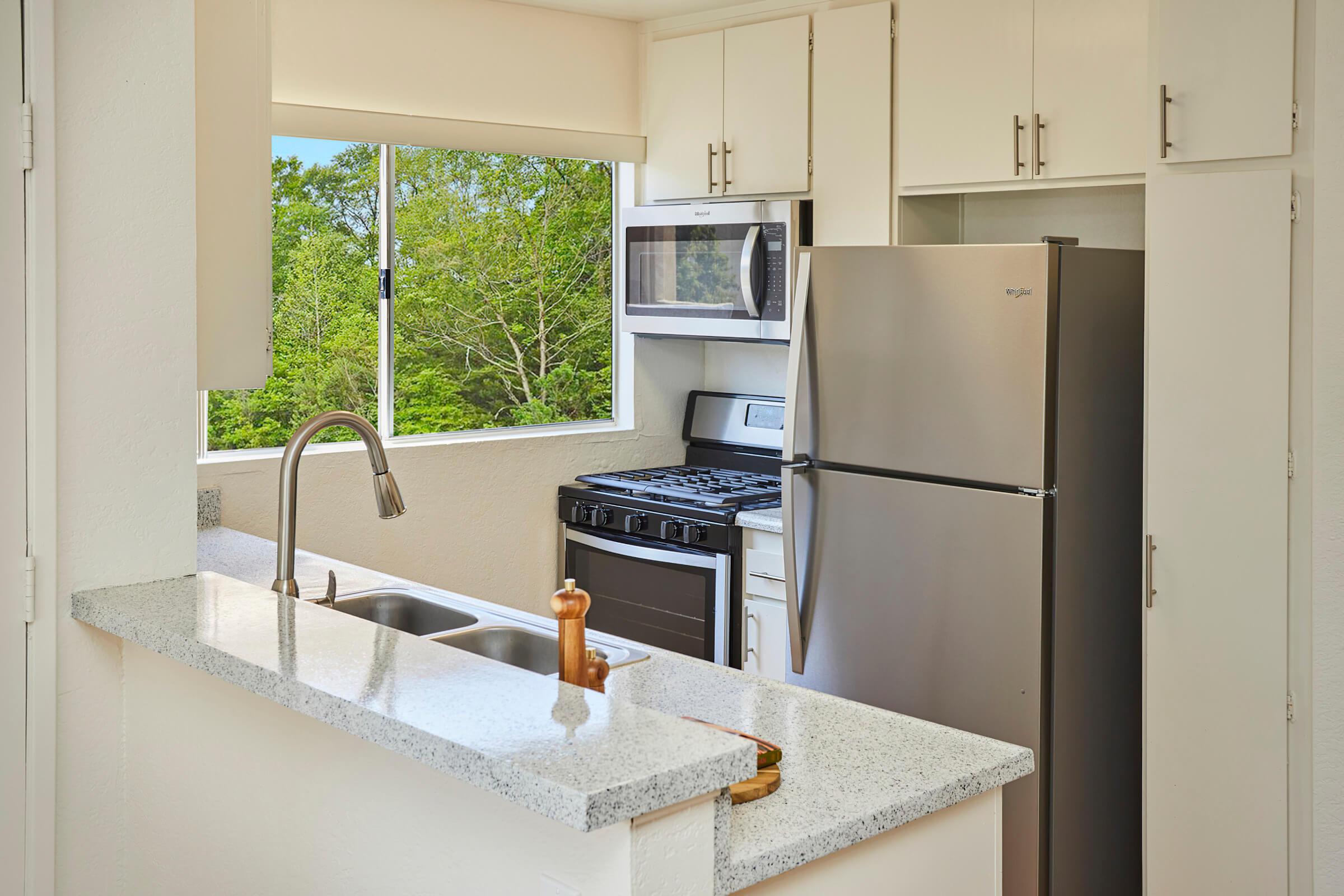 a kitchen with a sink and a mirror