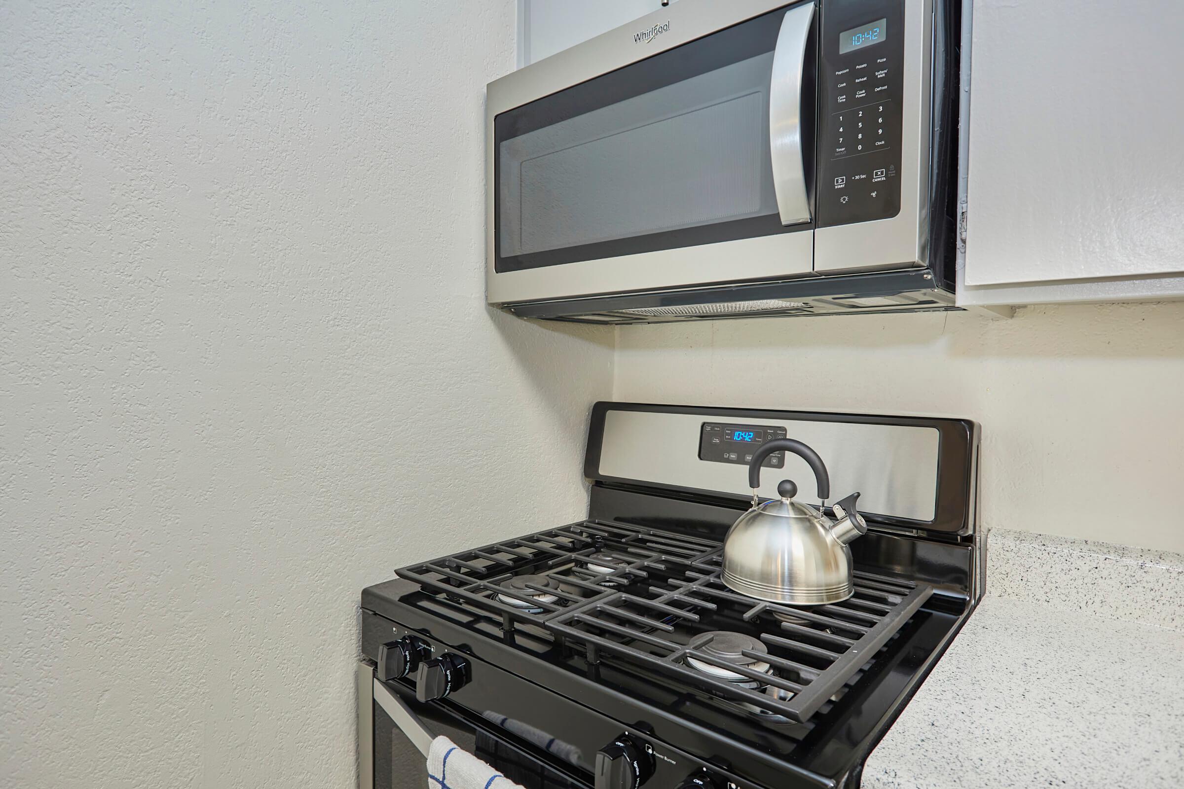 a stove top oven sitting inside of a kitchen