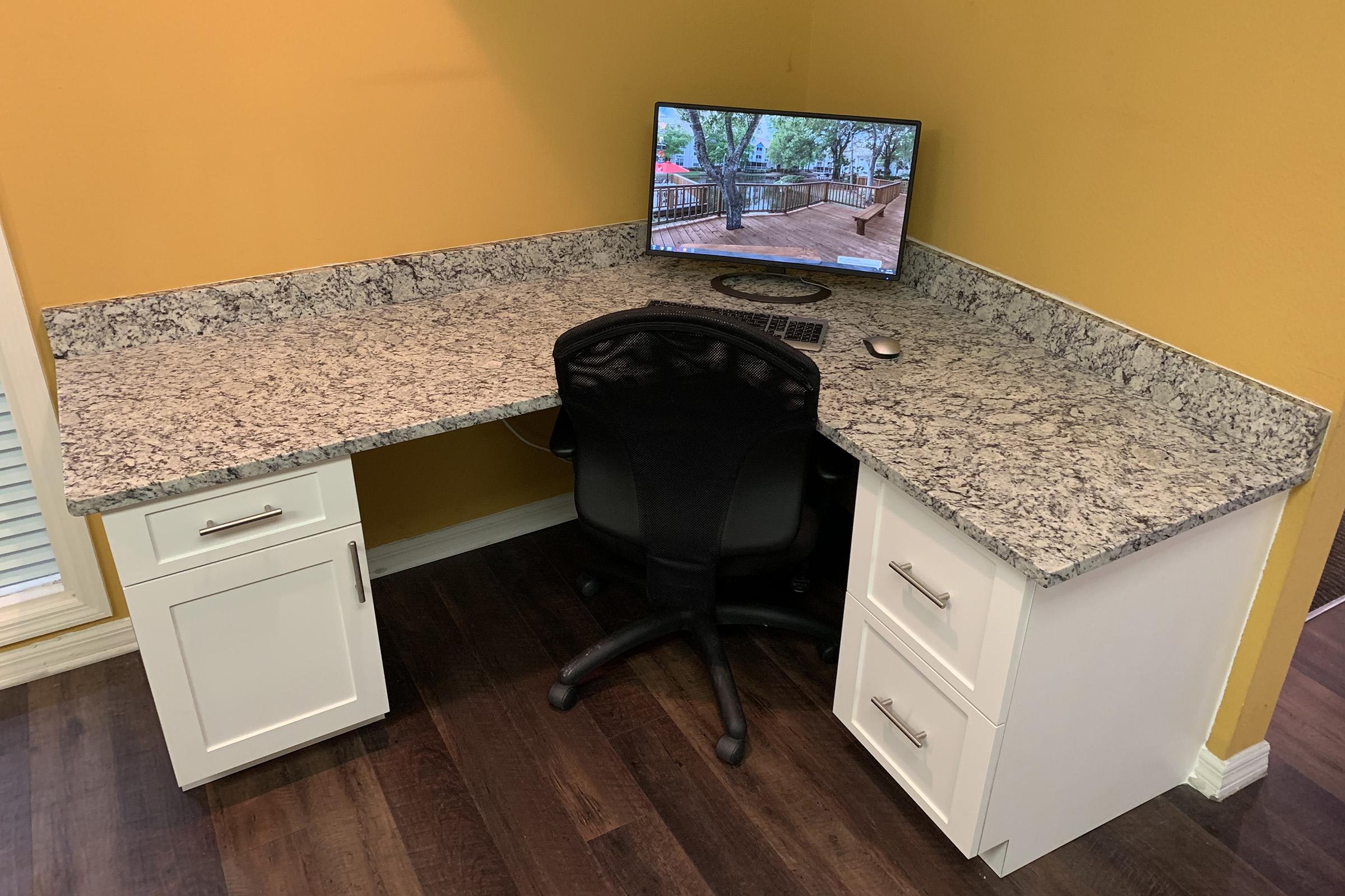 a laptop computer sitting on top of a wooden floor