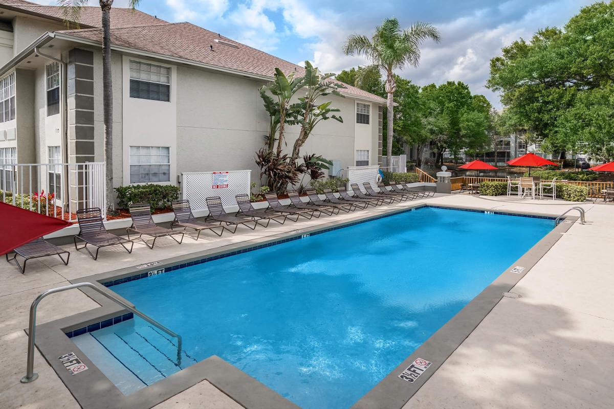 a house with a pool outside of a building