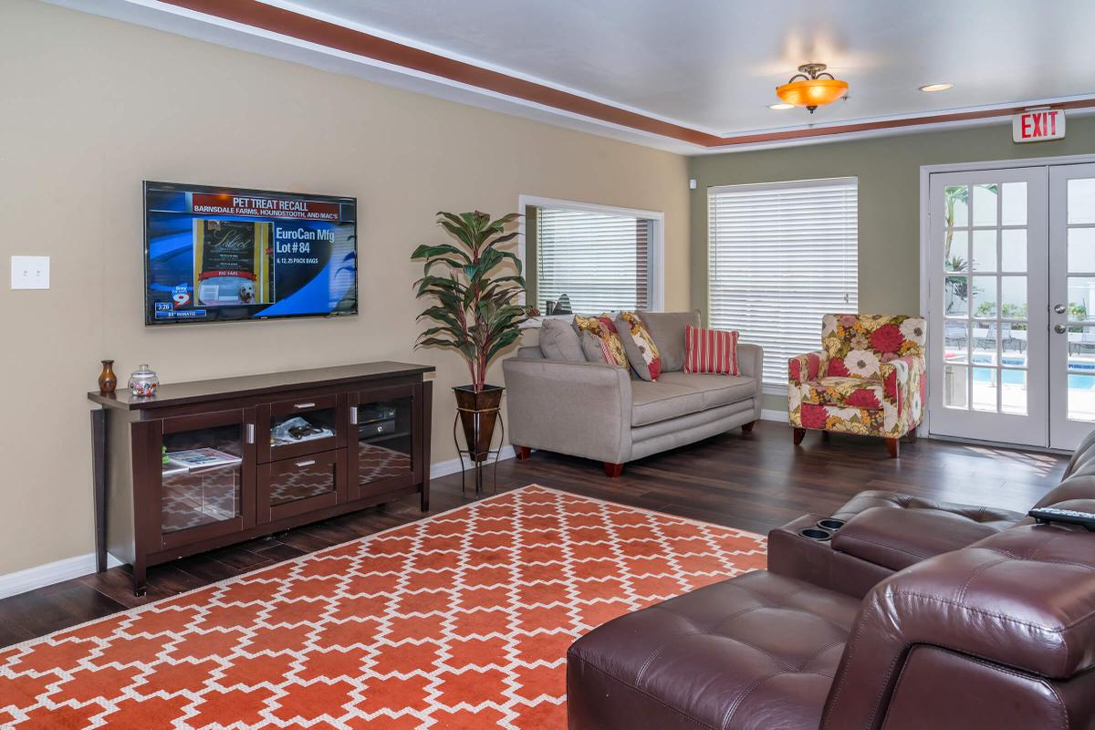 a living room filled with furniture and a flat screen tv