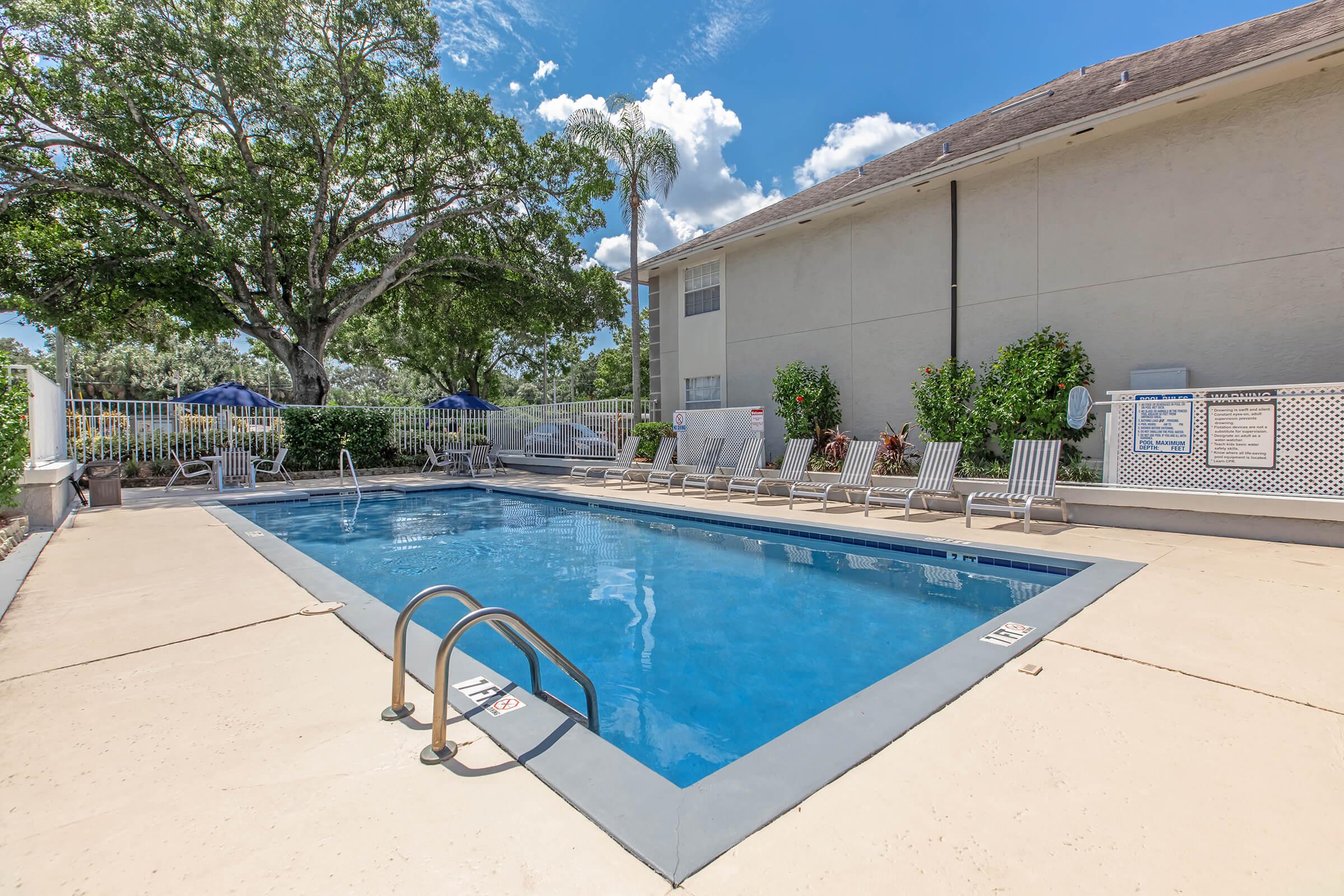 a house with a pool outside of a building