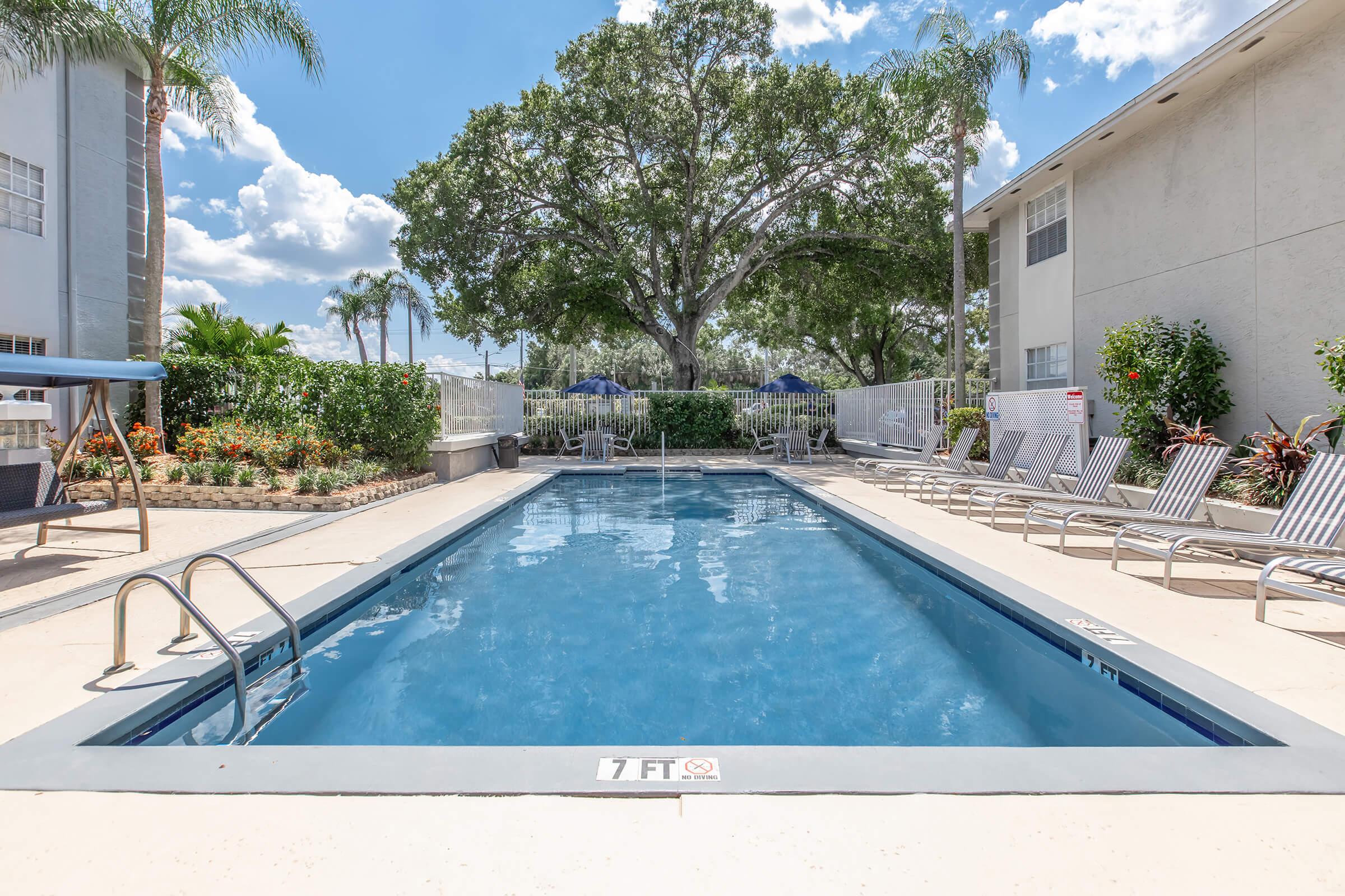 a house with a pool in front of a building