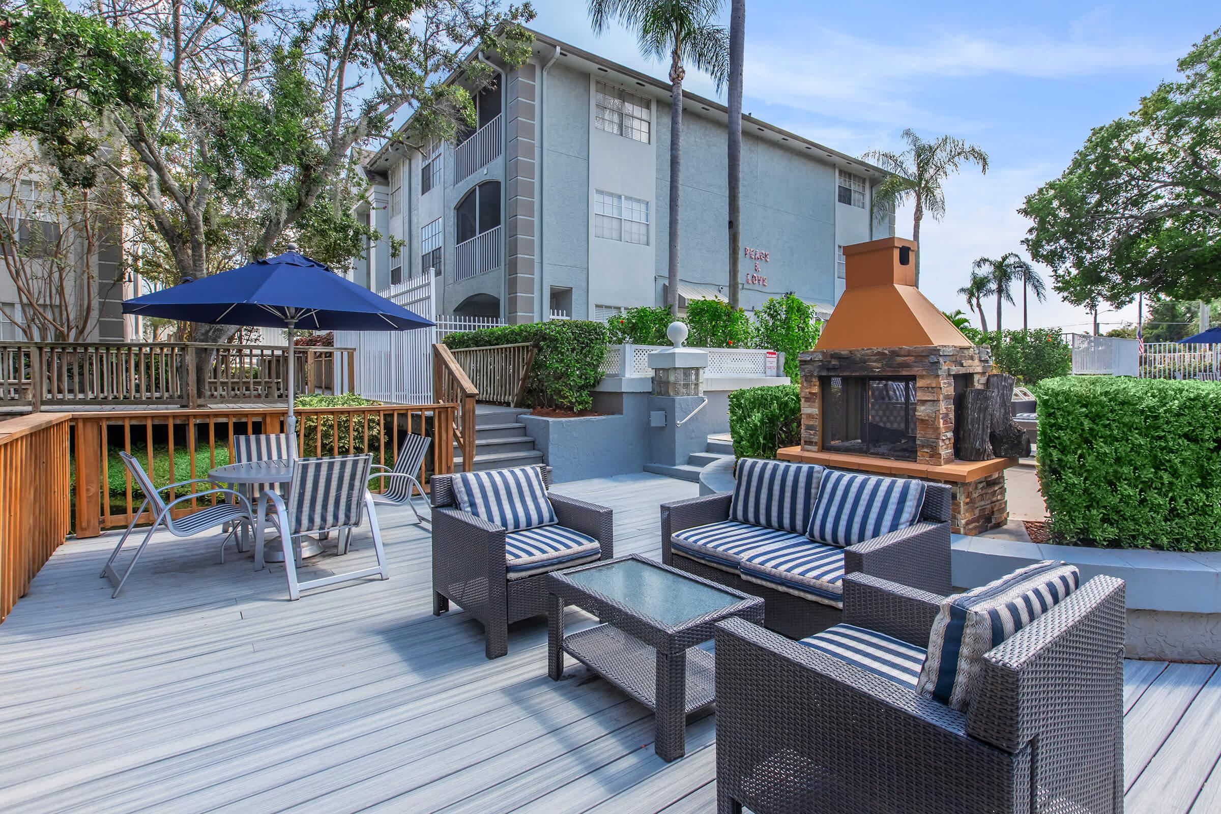 a group of lawn chairs sitting on top of a wooden fence