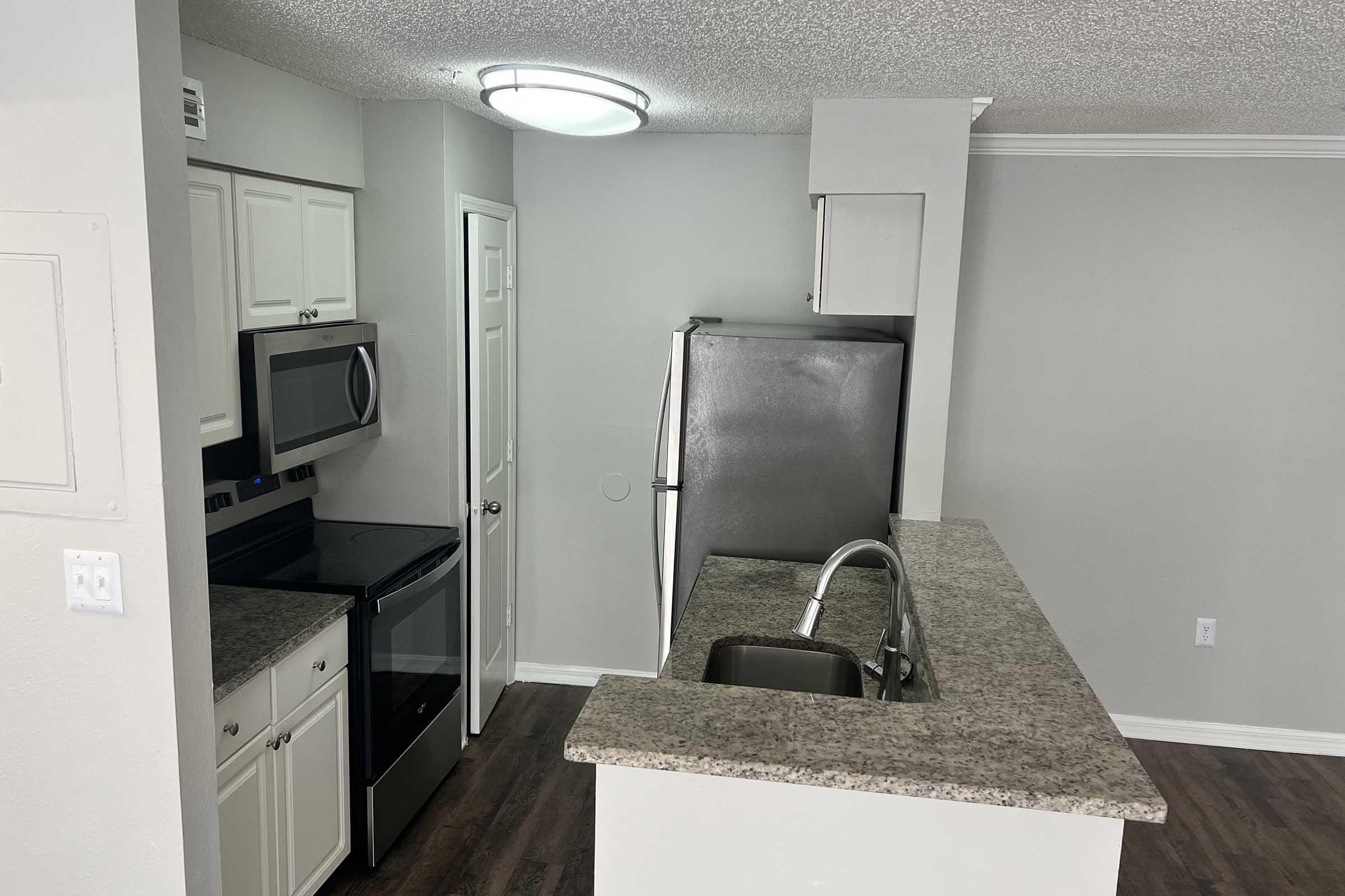 a kitchen with a sink and a mirror