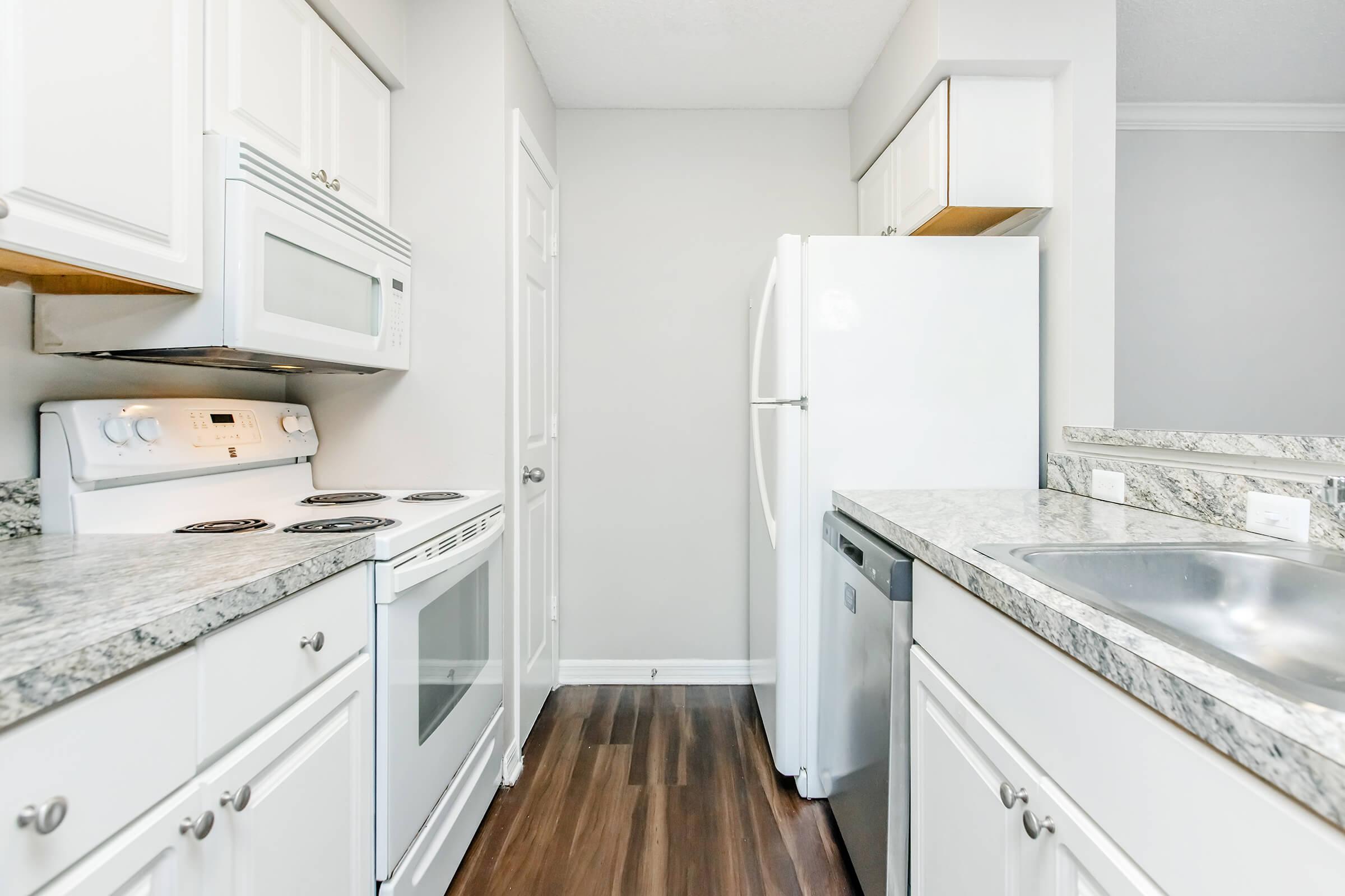 a kitchen with a stove sink and refrigerator