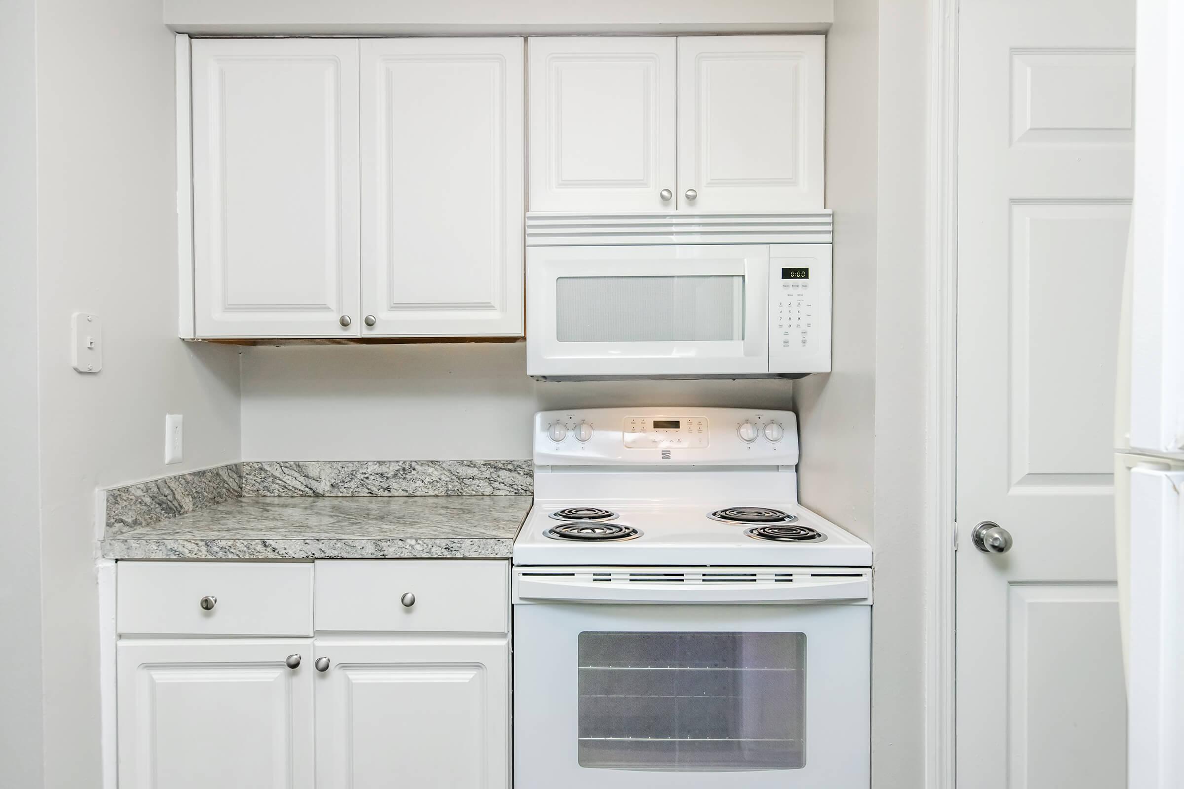 a stove top oven sitting inside of a kitchen