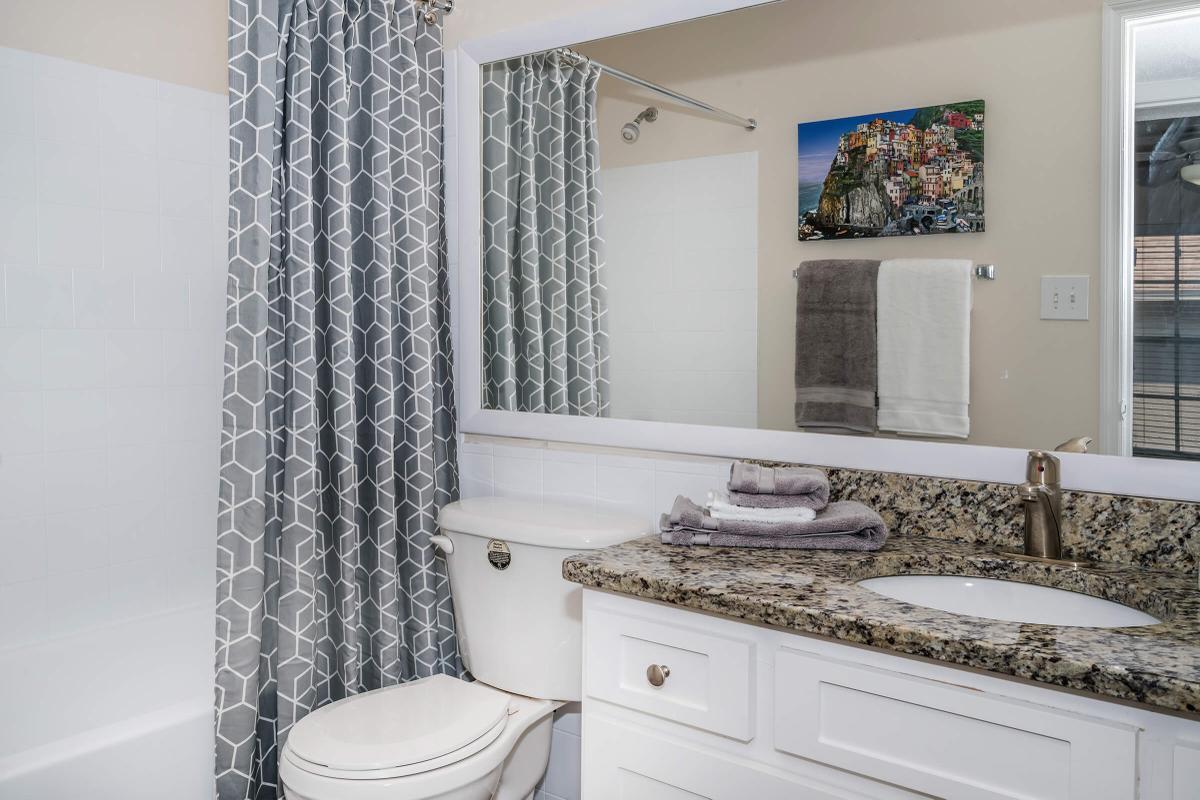 a white tub sitting next to a sink