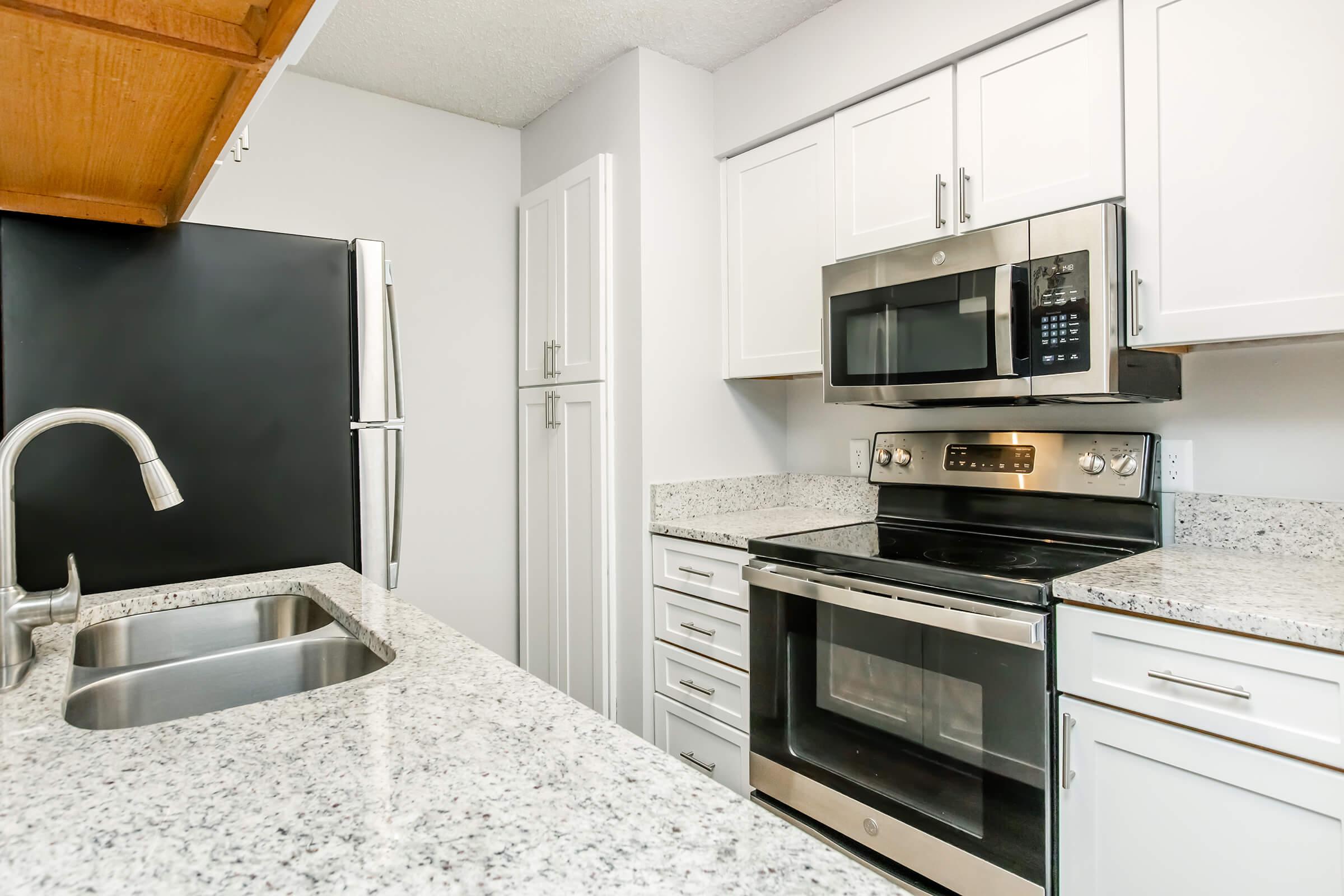 a kitchen with a sink and a microwave