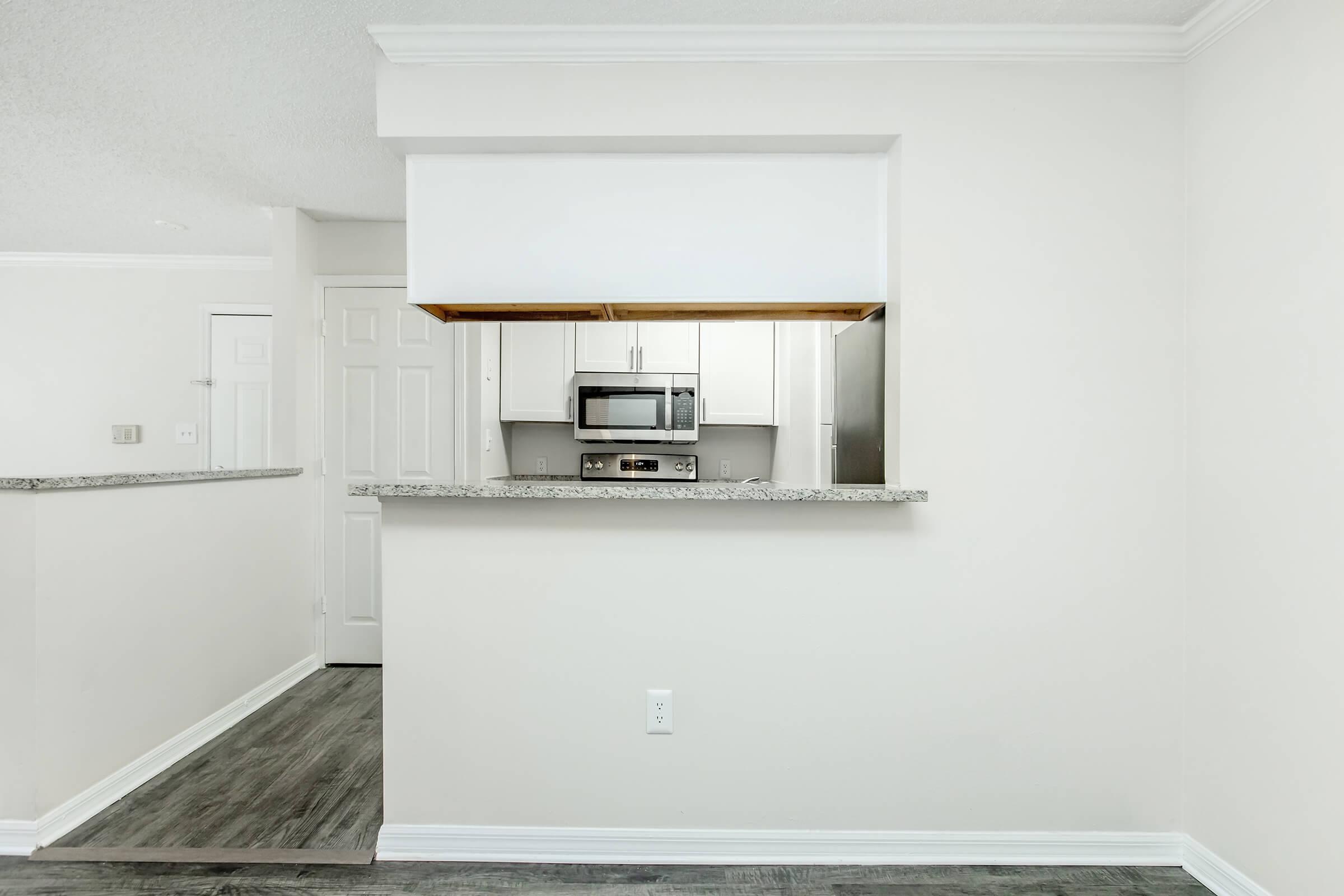 a kitchen with a sink and a mirror