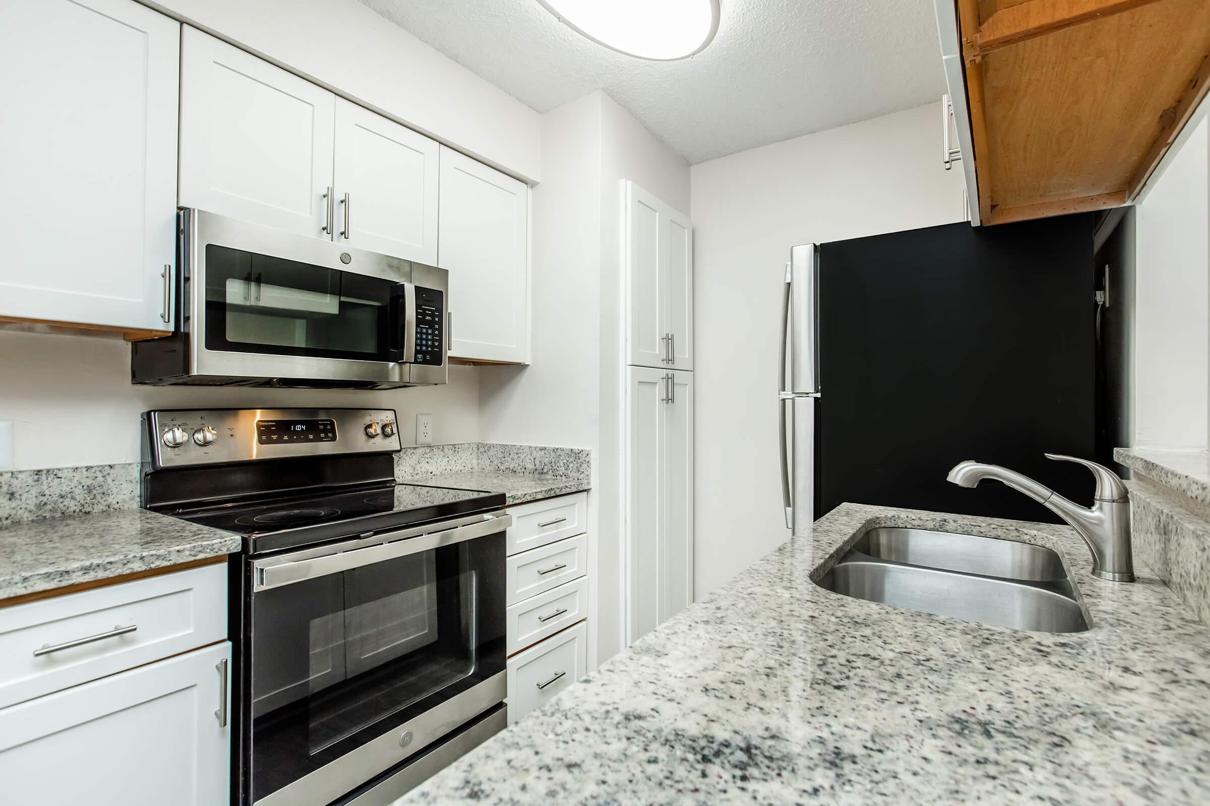 a kitchen with a stove top oven