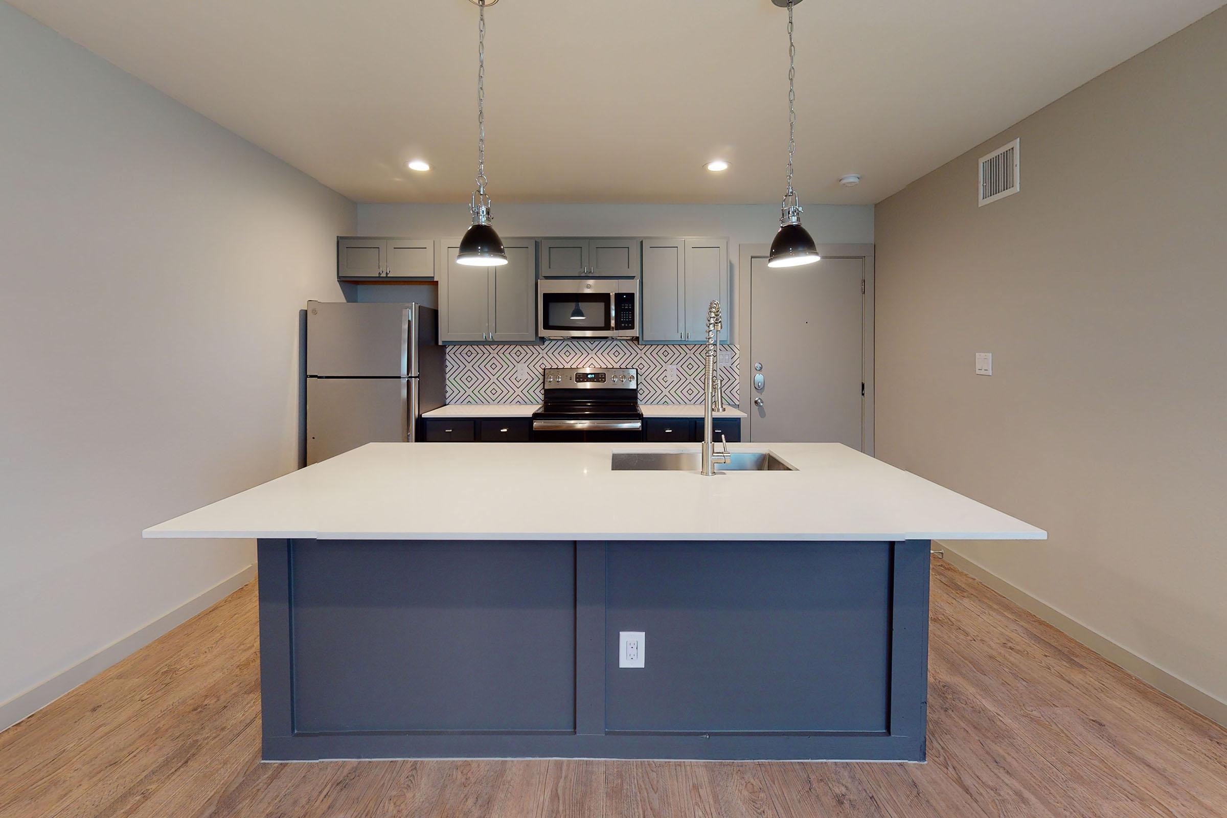 a vacant kitchen with stainless steel appliances