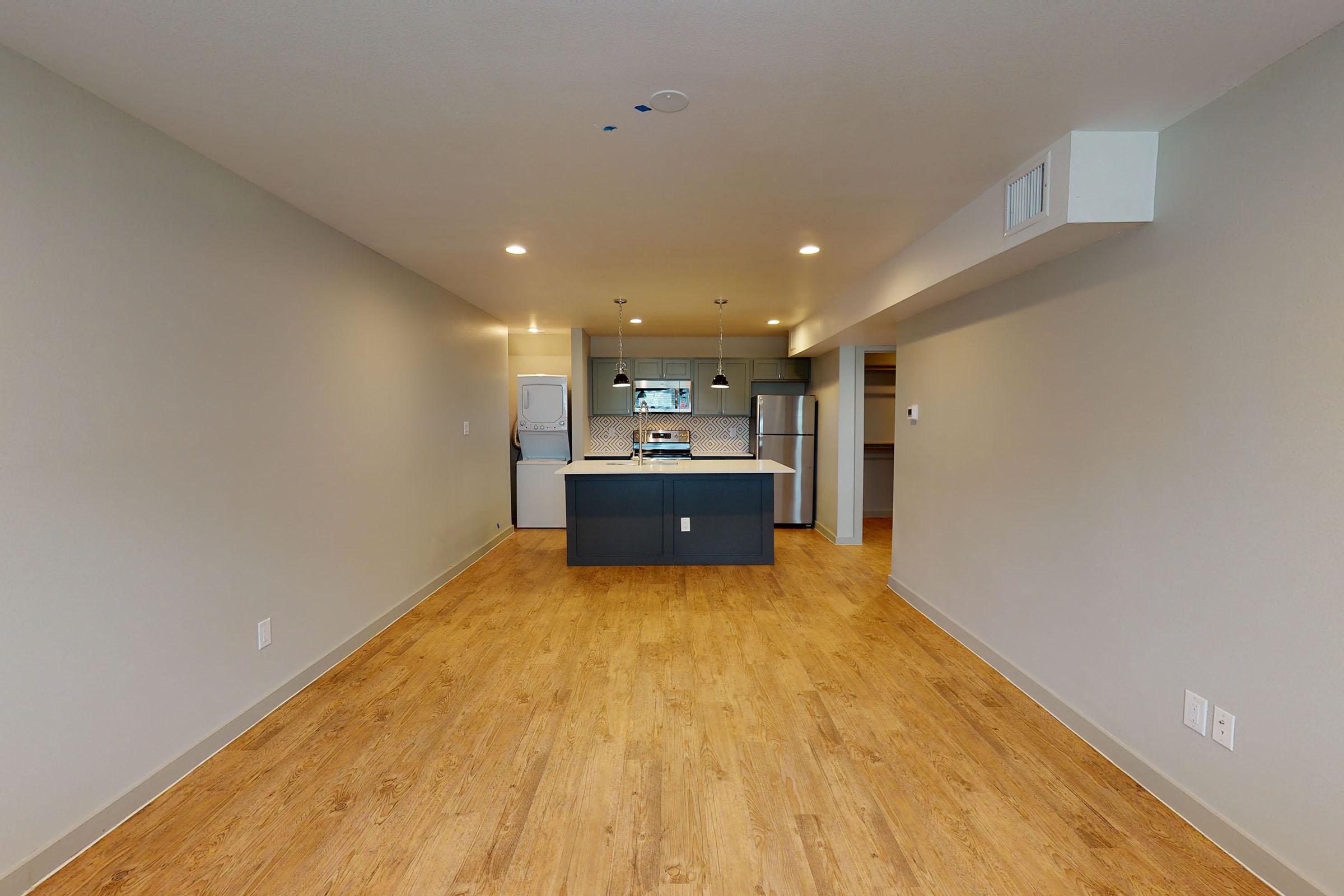an unfurnished apartment with wooden floors