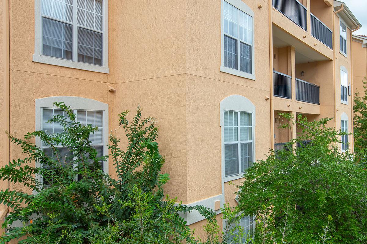 a house with bushes in front of a building