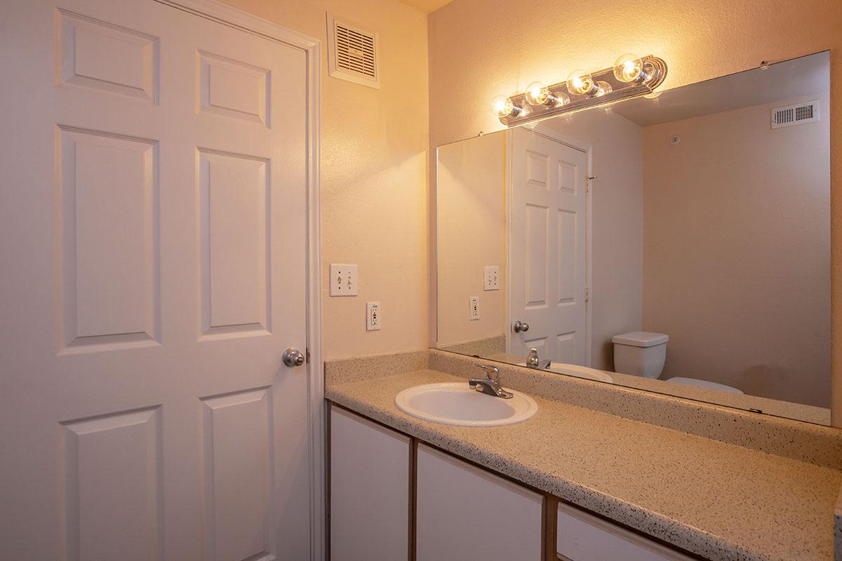 a room with a sink and a mirror