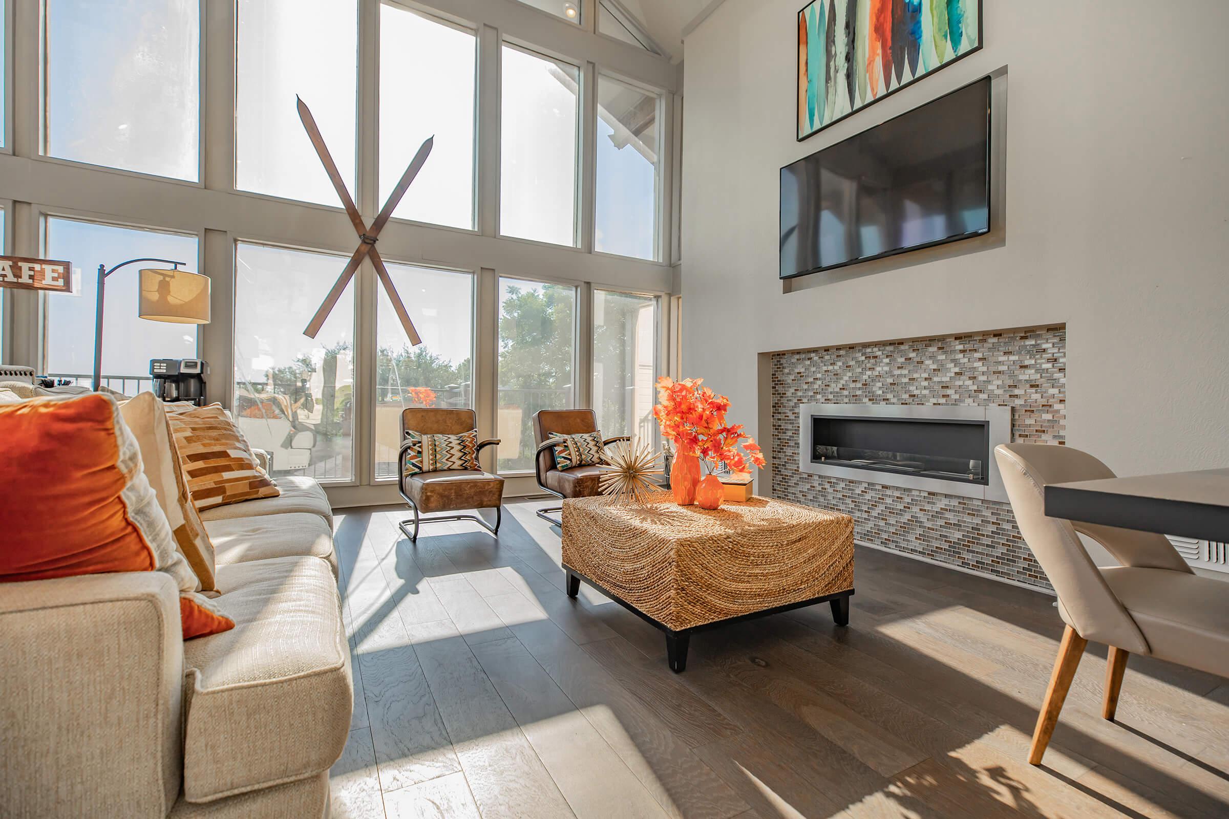 a living room filled with furniture and a large window