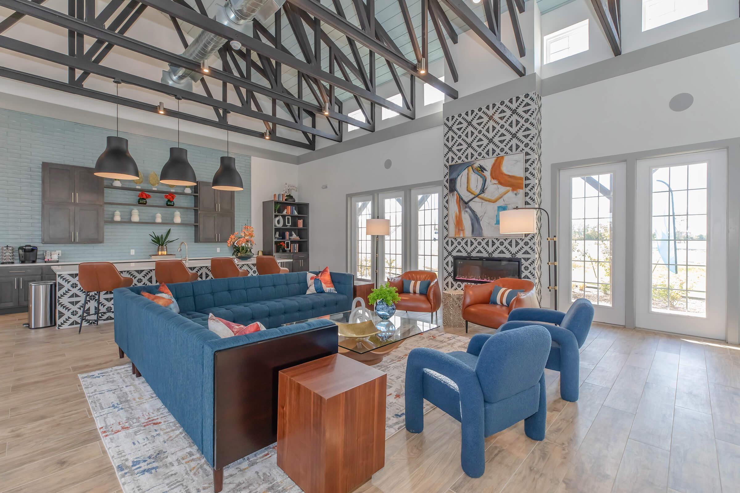 a living room filled with furniture and a large window