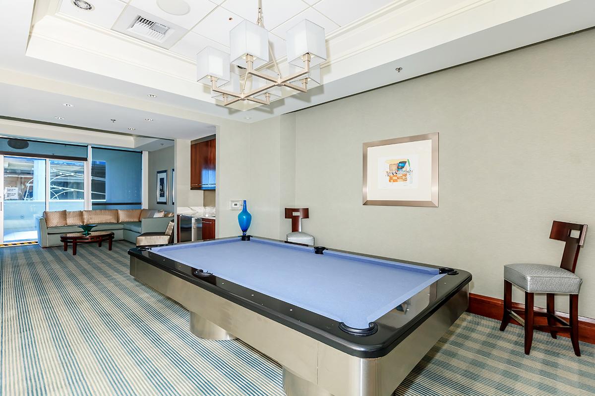 a bedroom with a bed and desk in a room