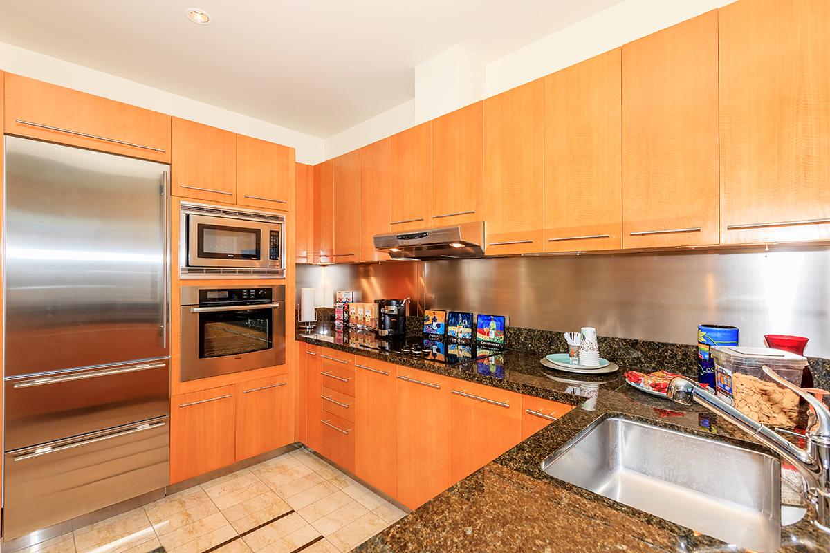 a kitchen with stainless steel appliances and wooden cabinets