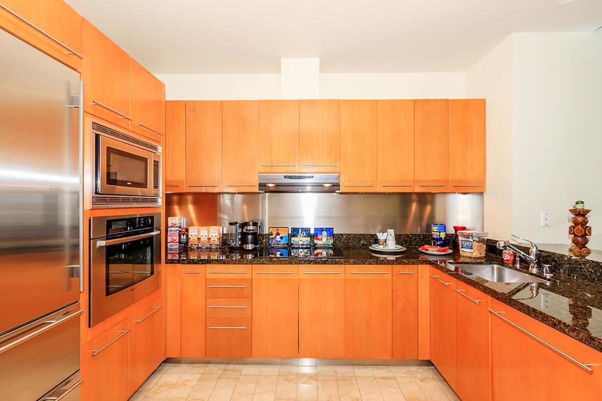 a kitchen with stainless steel appliances and wooden cabinets