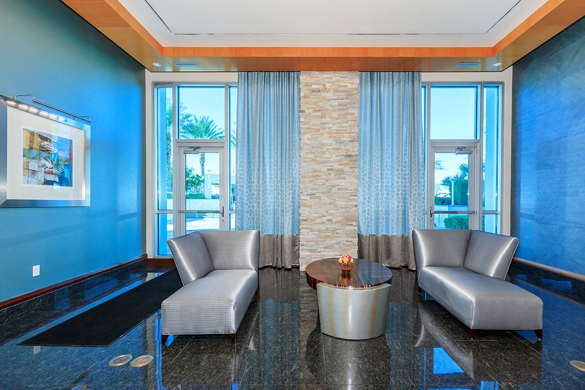 a living room filled with furniture and a large window