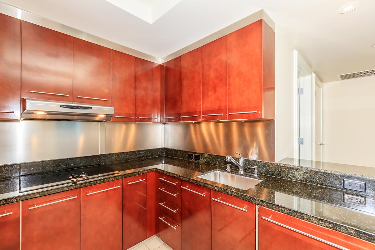 a kitchen with stainless steel appliances and wooden cabinets