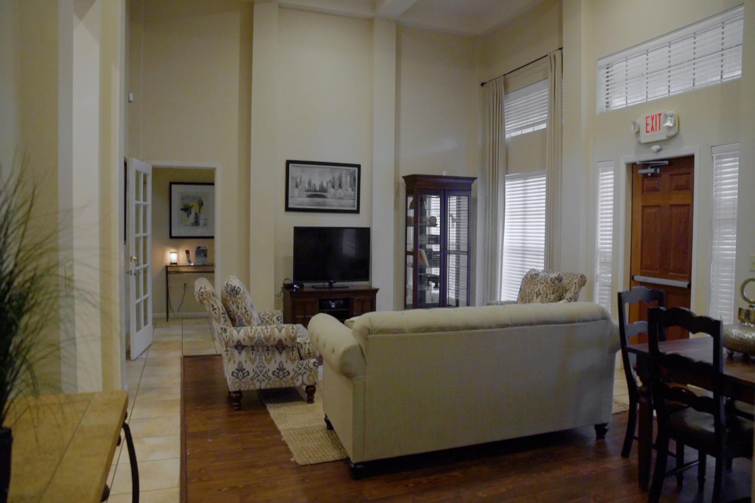 a living room filled with furniture and a large window