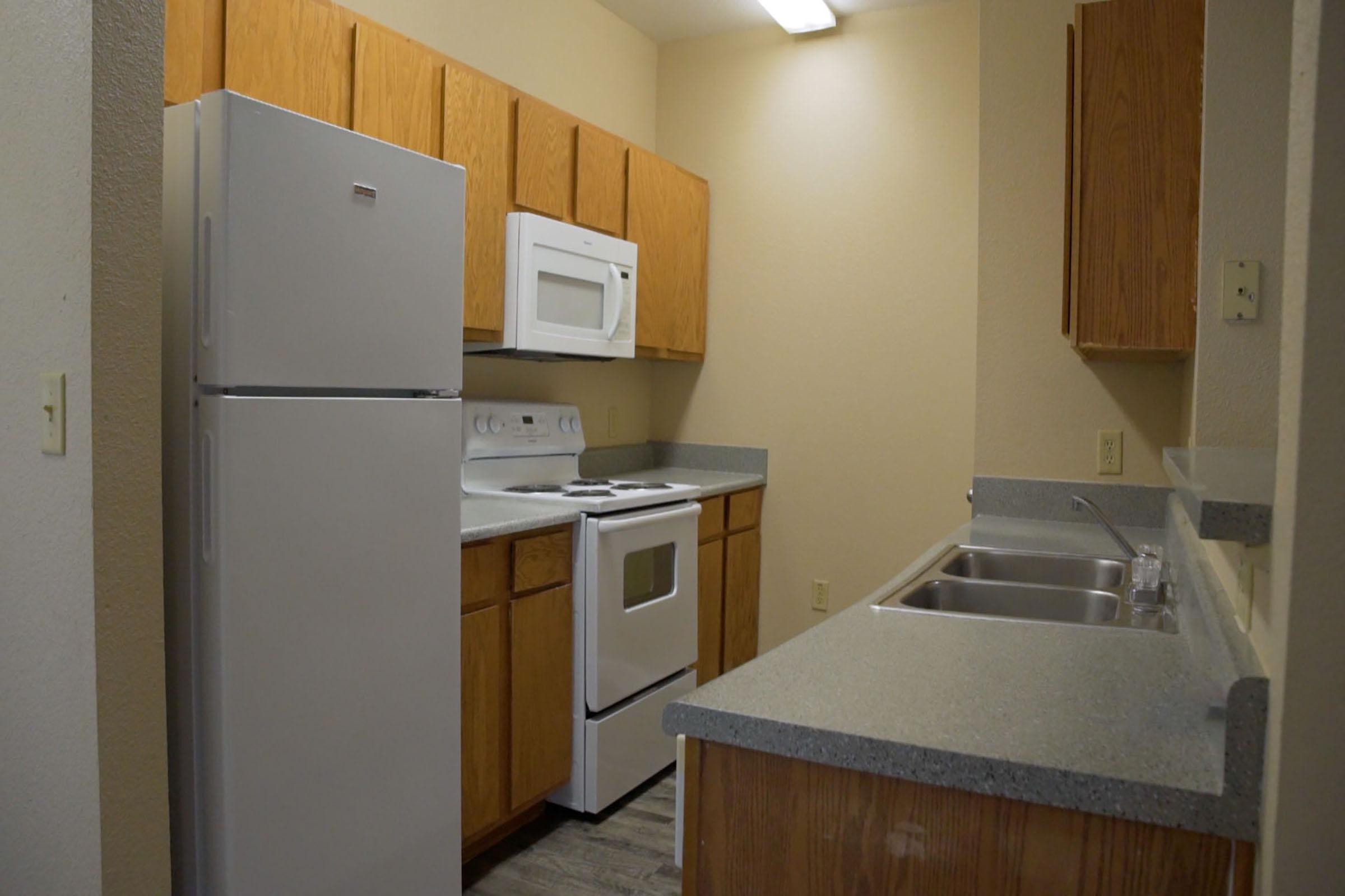 a kitchen with a sink and a refrigerator