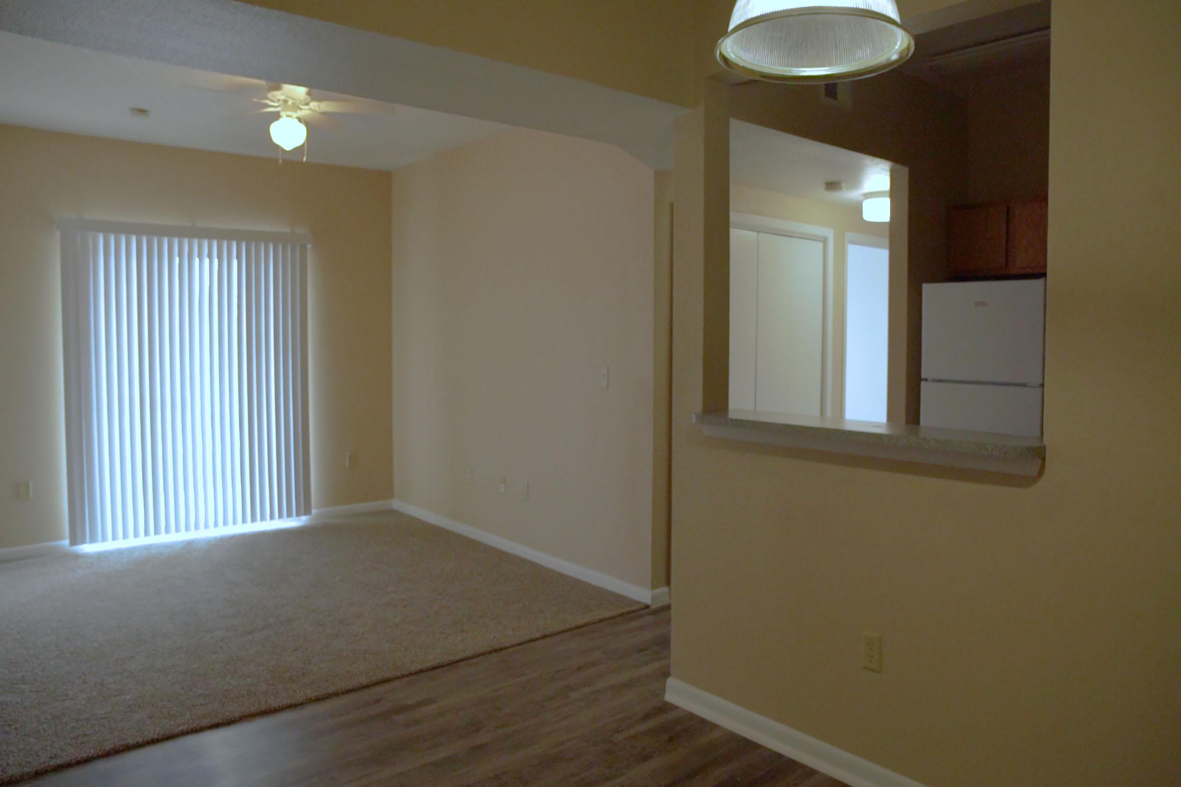 a large empty room with a sink and a window