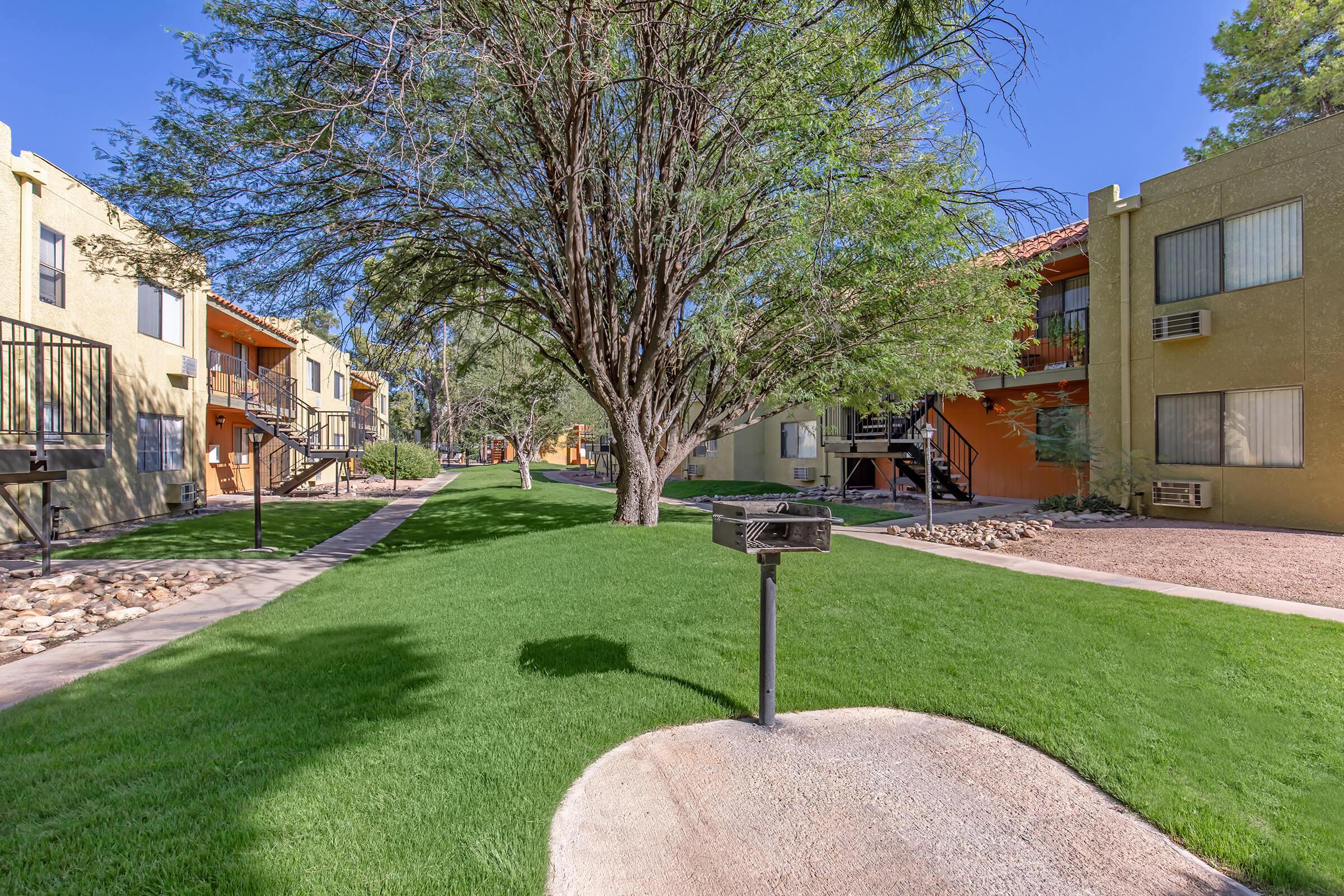 a large lawn in front of a brick building