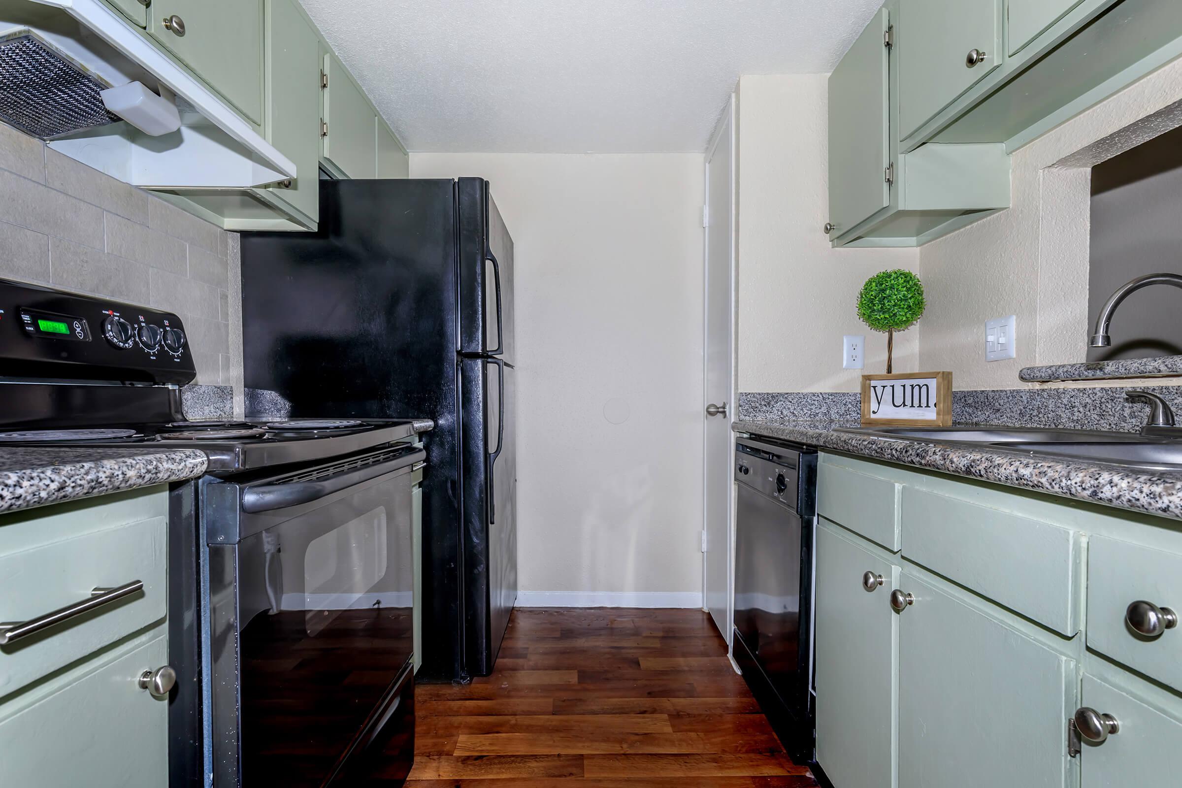 a stove top oven sitting inside of a kitchen