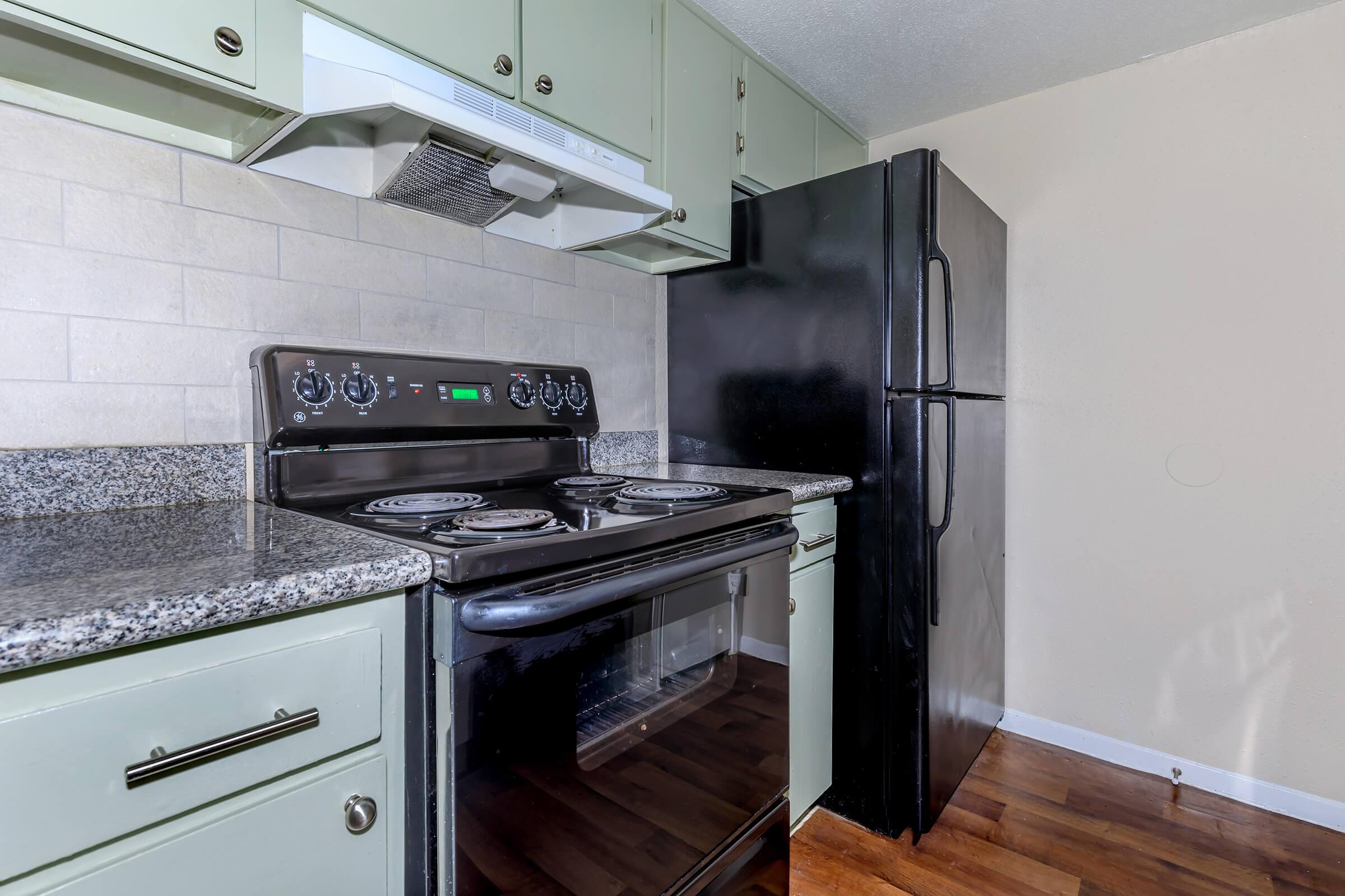 a stove top oven sitting inside of a kitchen