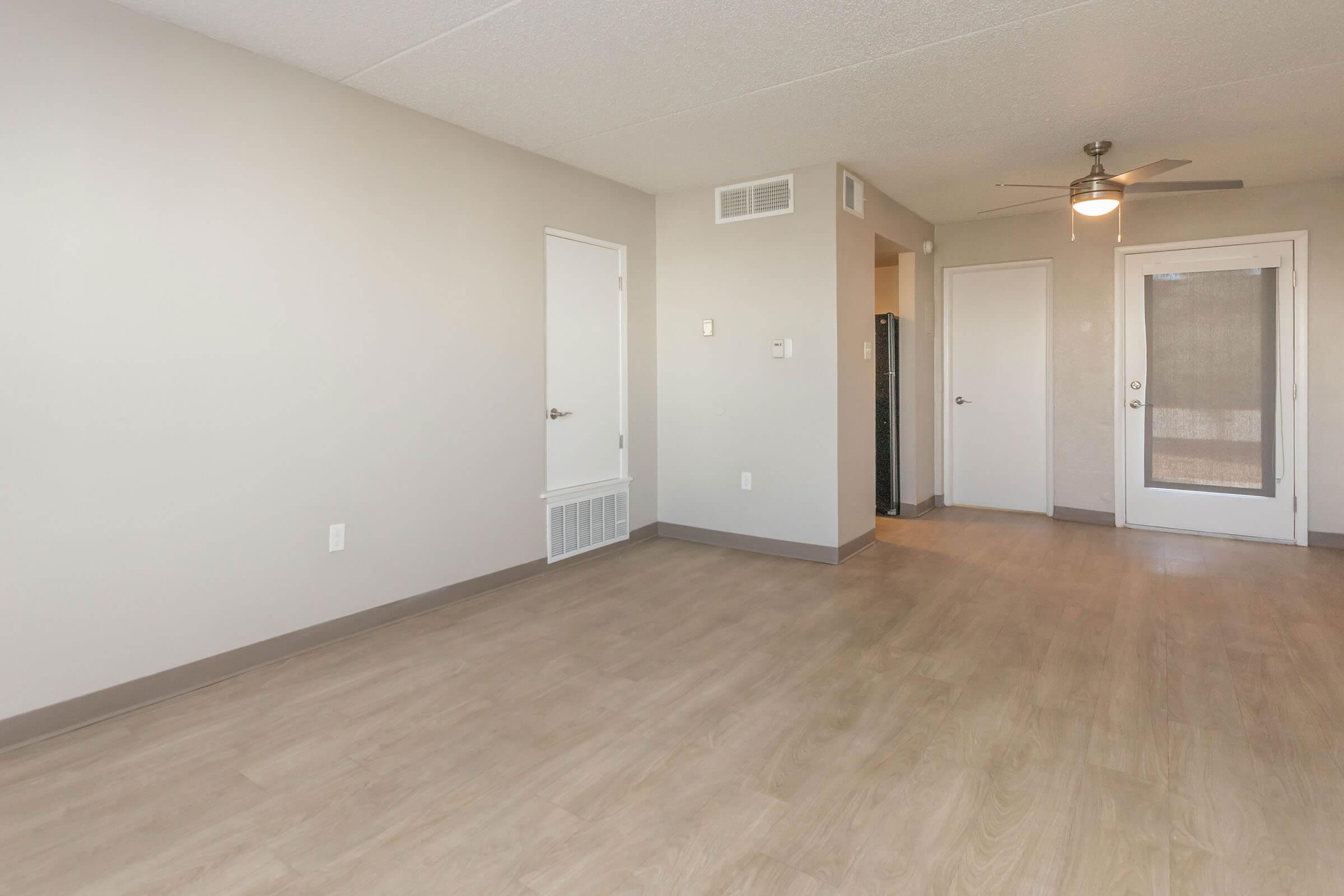 a large empty room with a wooden floor