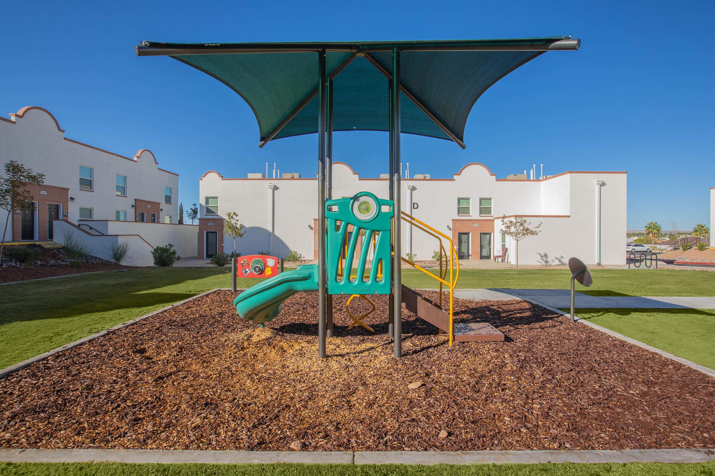 a couple of lawn chairs sitting on top of a grass covered field