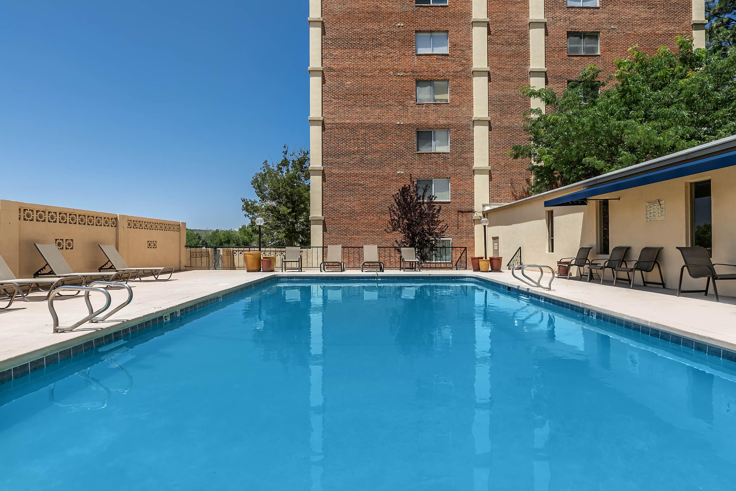 a blue pool of water in front of a building