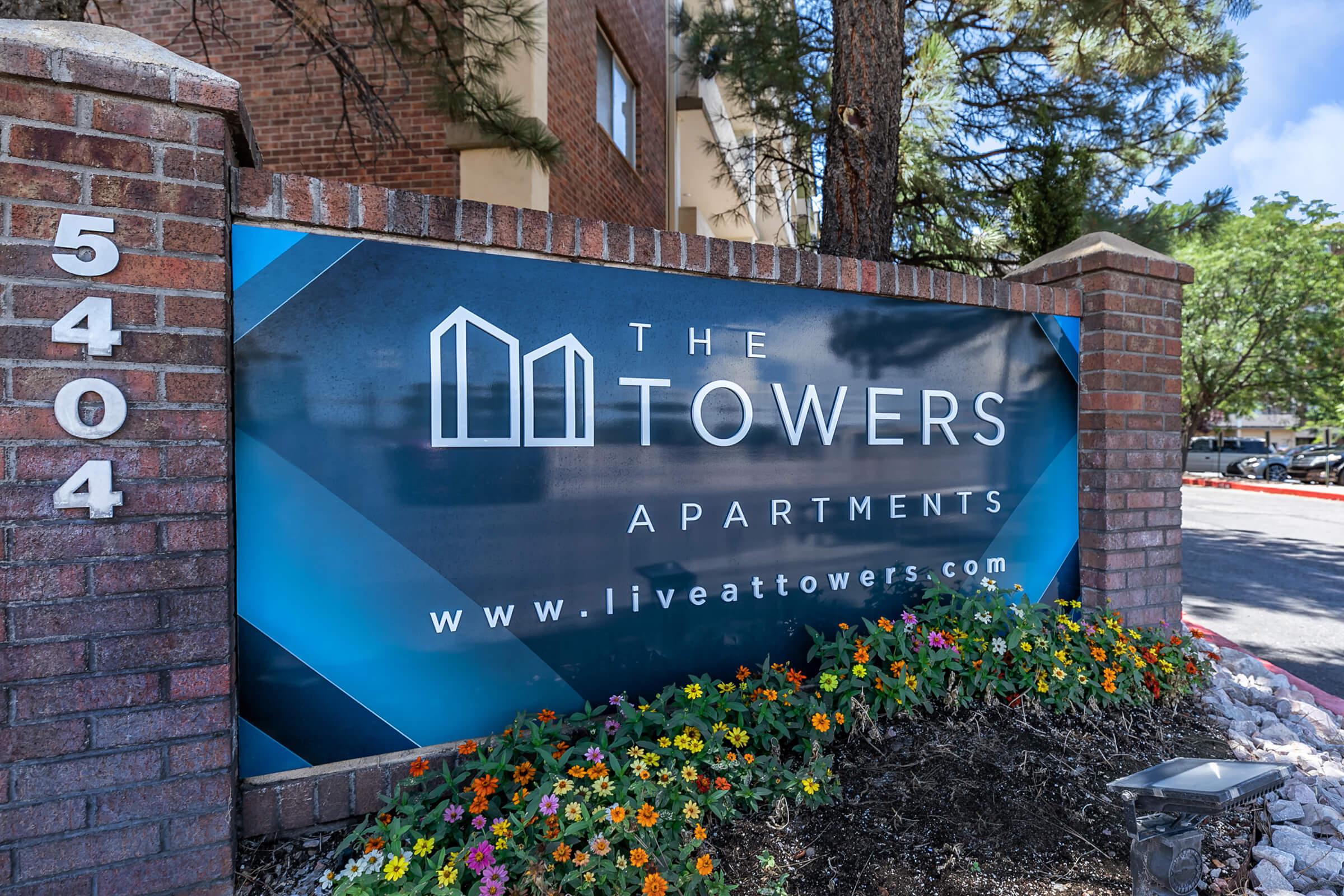 a sign in front of a brick building