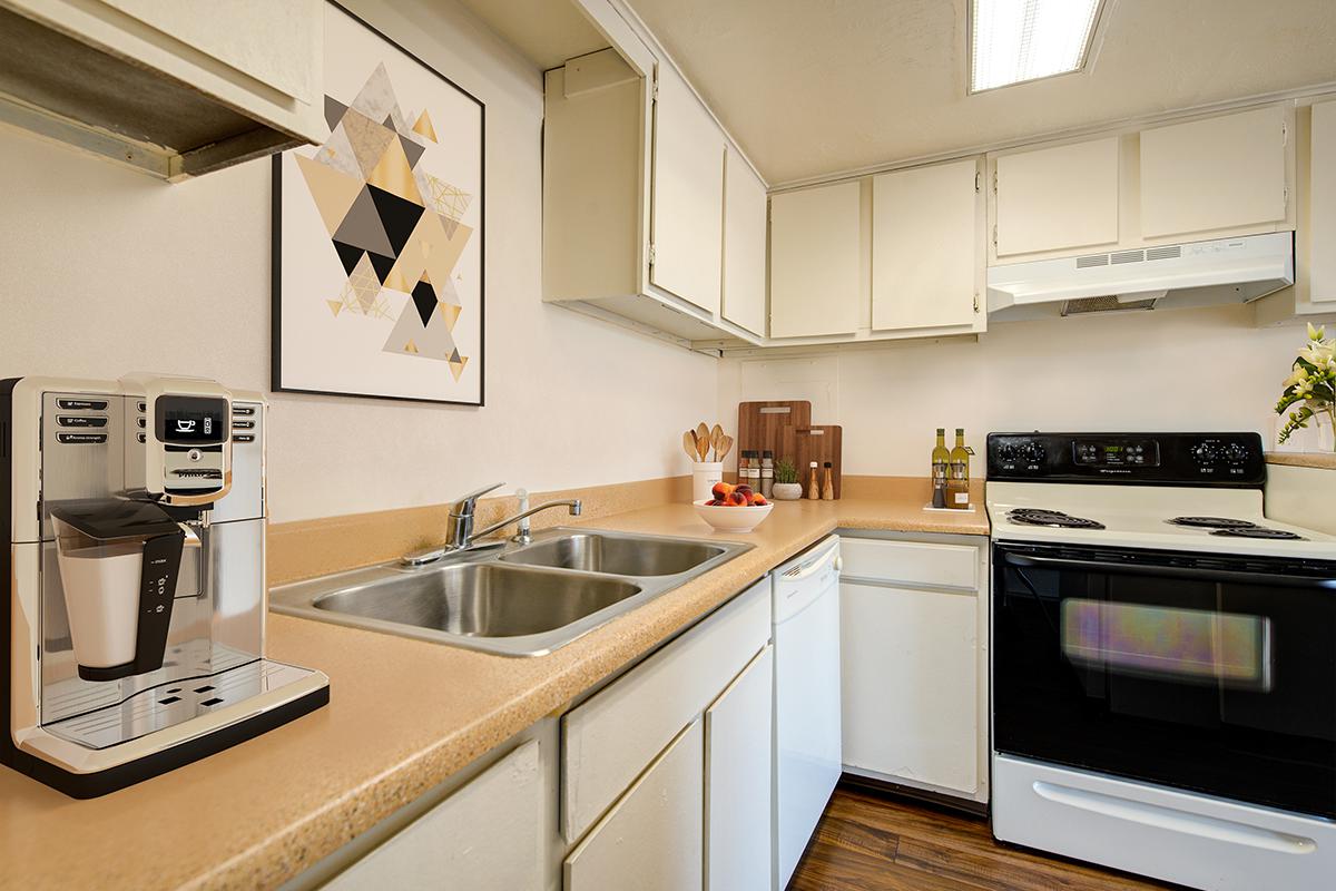 a stove top oven sitting inside of a kitchen