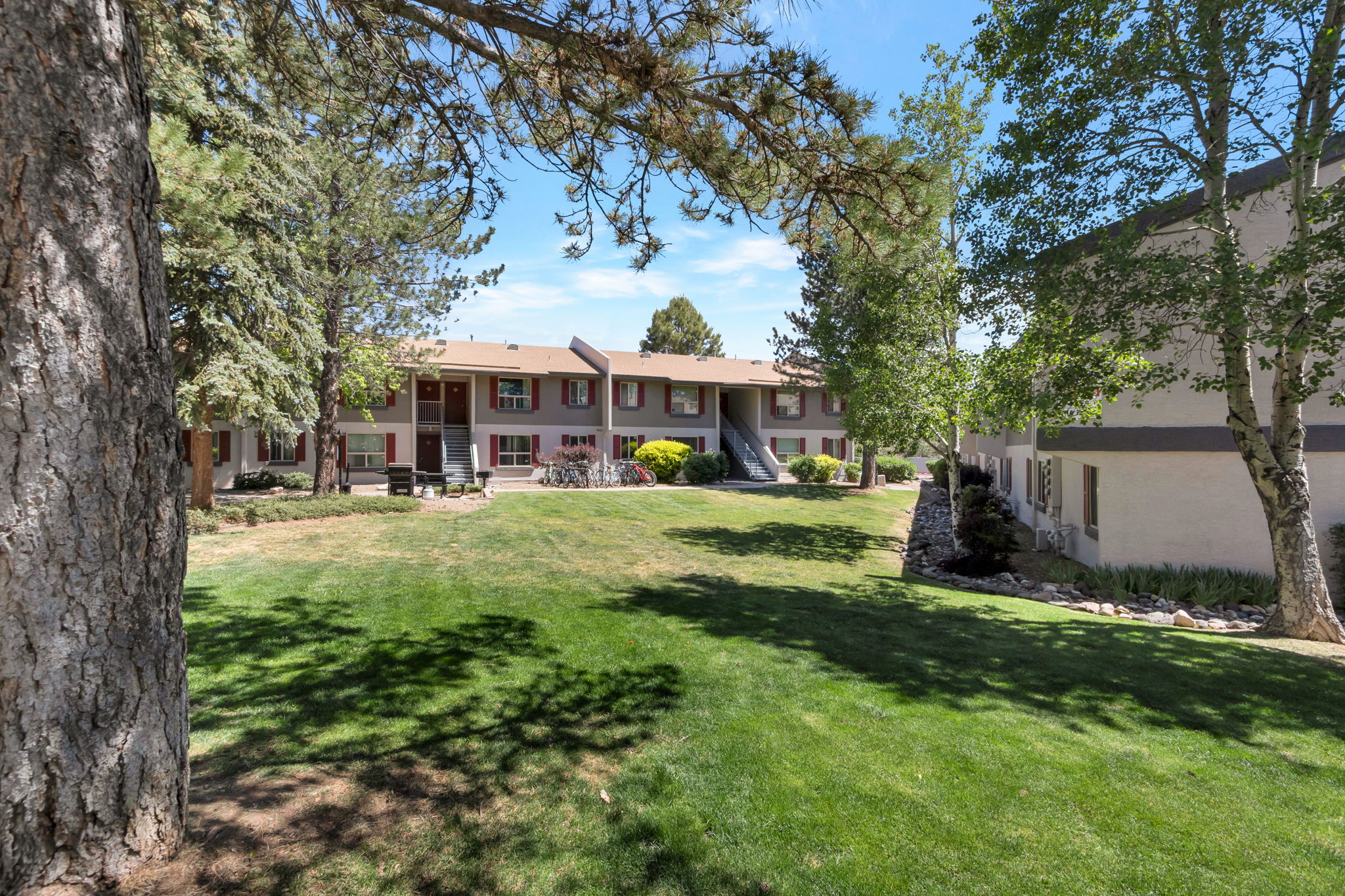 Discover a serene oasis where lush green spaces meet charming architecture, creating the perfect setting for relaxation and community living just steps from your door.
