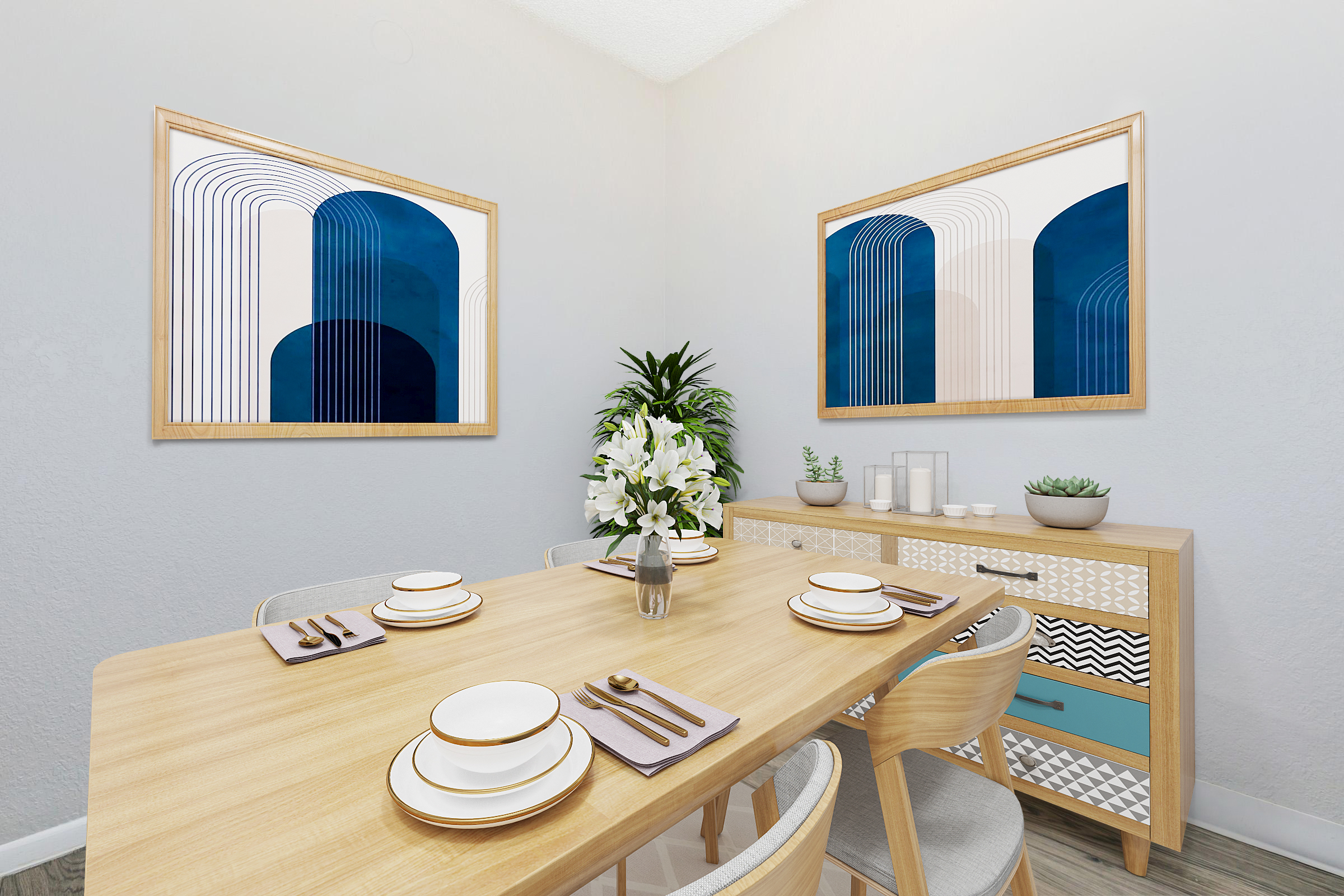 A modern dining room featuring a wooden table set for four, adorned with white plates and napkins. Two abstract art pieces in blue and white hang on the wall, complemented by potted plants. A sideboard with geometric patterns adds a stylish touch, creating a cozy and inviting atmosphere.