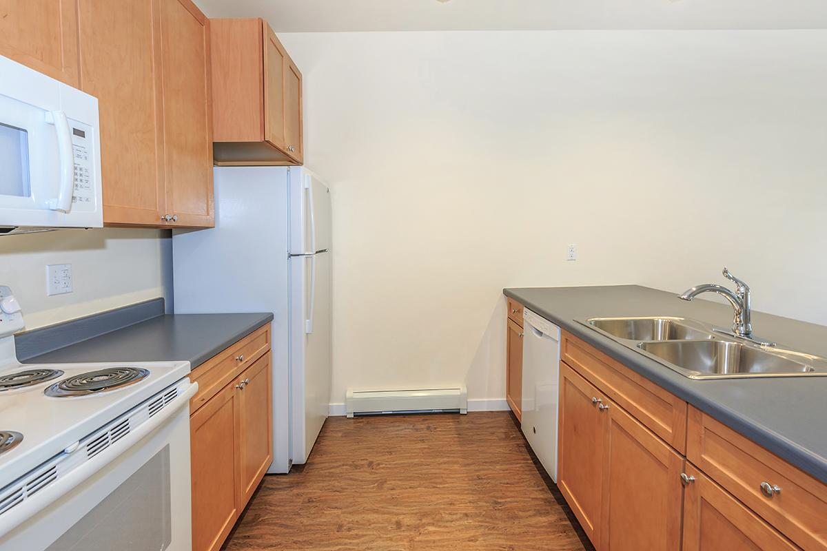 a kitchen with stainless steel appliances and wooden cabinets