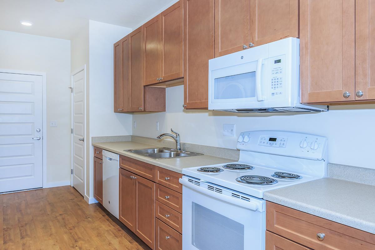 a kitchen with wooden cabinets and a microwave